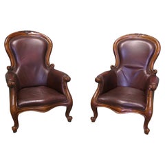 A Pair of Victorian Leather Spoon Back Easy Chairs.