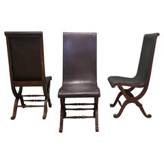 A Set of 3 Mid Century Leather and Oak Fireside Sling Chairs by Pierre Lottier