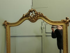 A Large French Rococo Gilt Console Mirror Decorated with Flowers and Ribbons