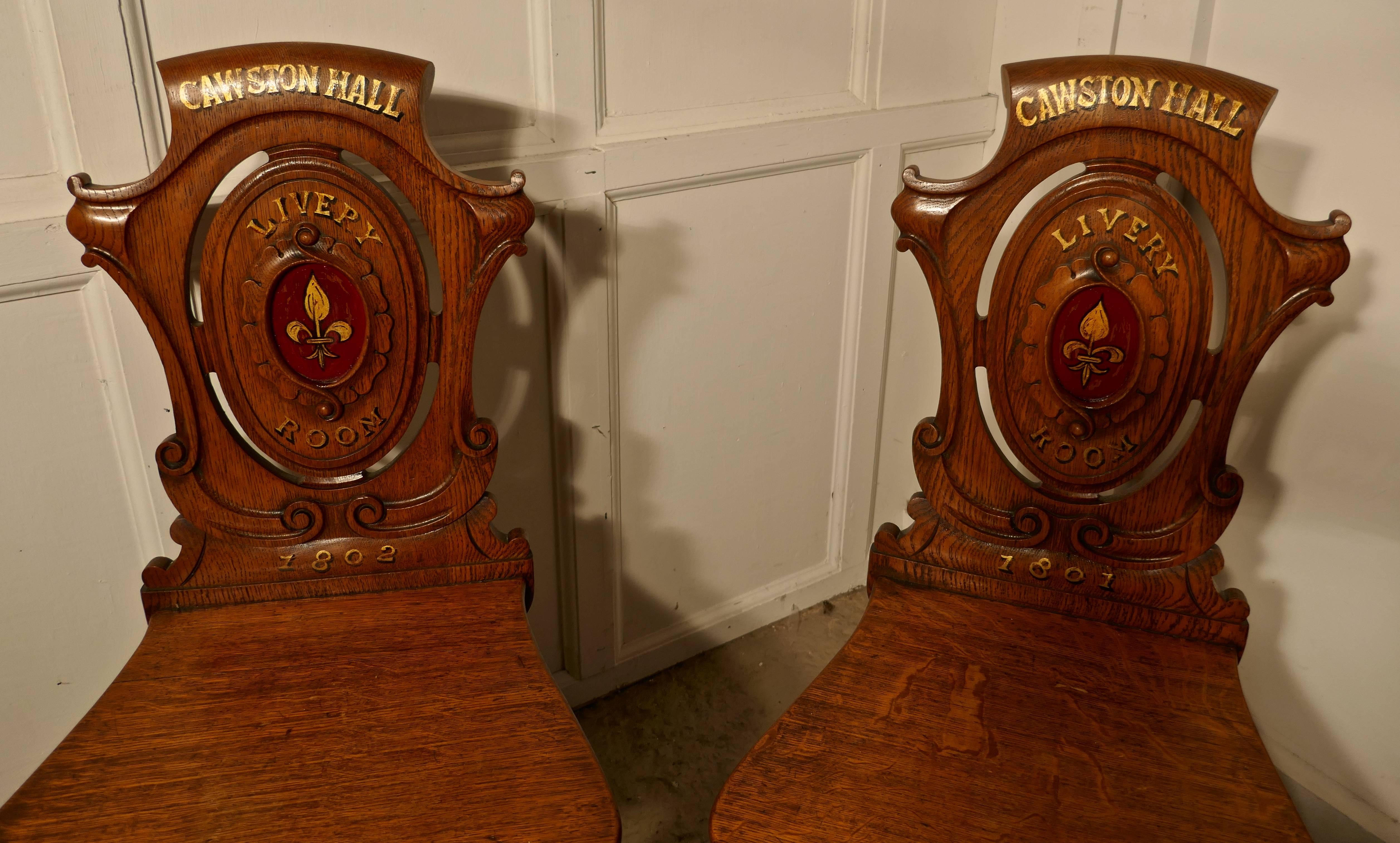 Early 19th century golden oak hall chairs, from Cawston Hall Livery Room.

These are a delightful hall chairs, the superbly carved backs are painted with their date and a fleur-de-lis crest, they stand on slender shaped and fluted legs.
There are