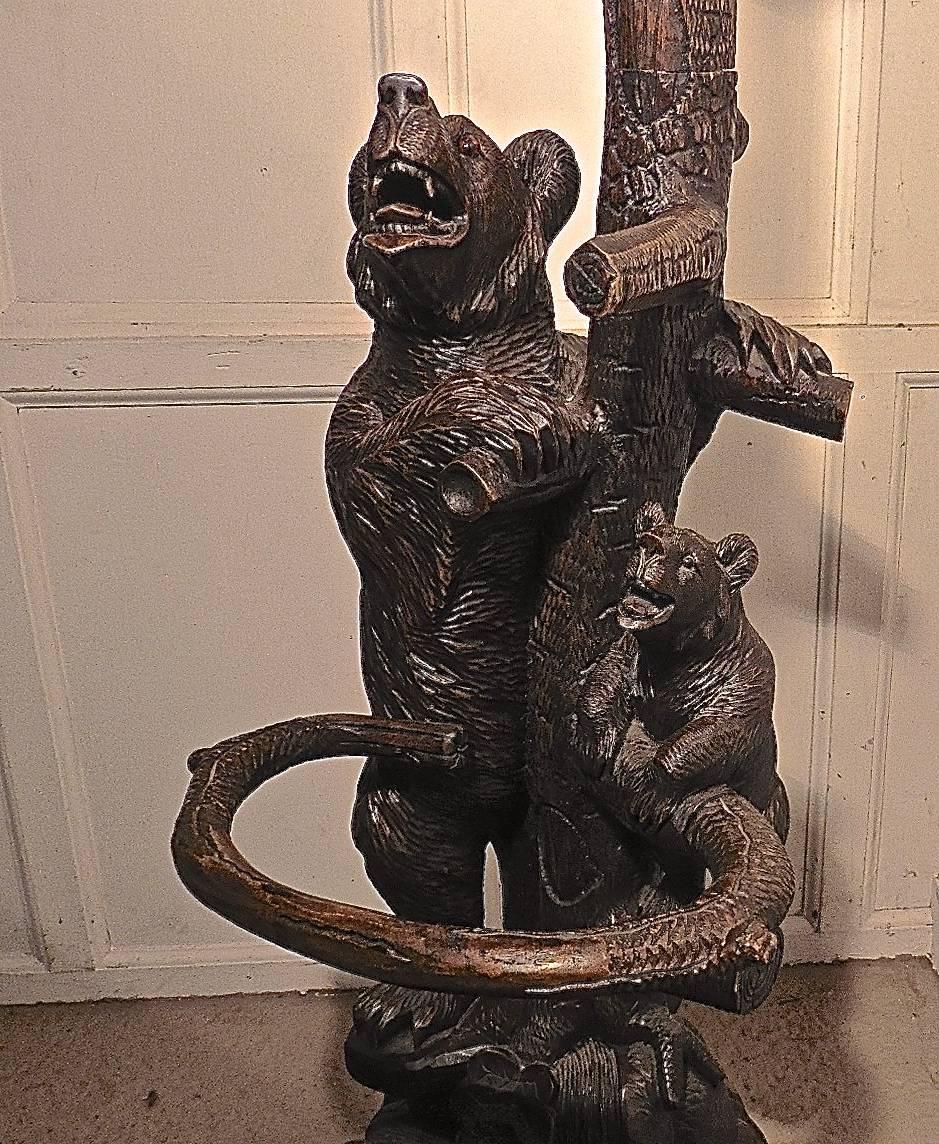 This is a very impressive piece dating from the turn of the 19th century, carved in the Black Forest we have three bears, the mother bellowing from below, to the largest cub who has climbed to the top of the tree while the smaller cub roars at her