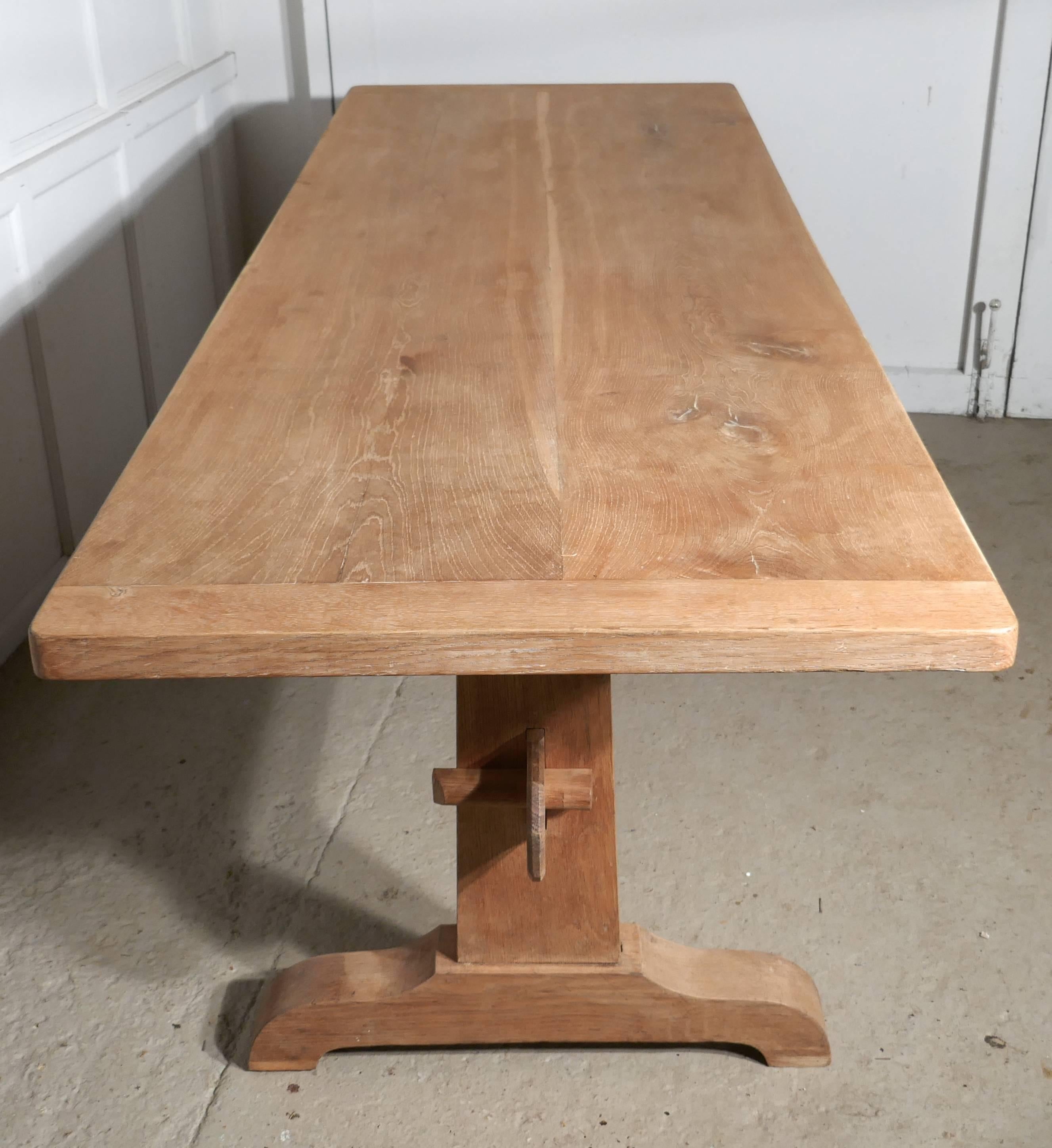 This is a good sturdy table, it has a solid oak thick two plank top is 2” thick and it has cleated (breadboard) ends, the table is very pale oak it has a good naturally faded patina.
The table legs are in the refectory style with a high Stretcher