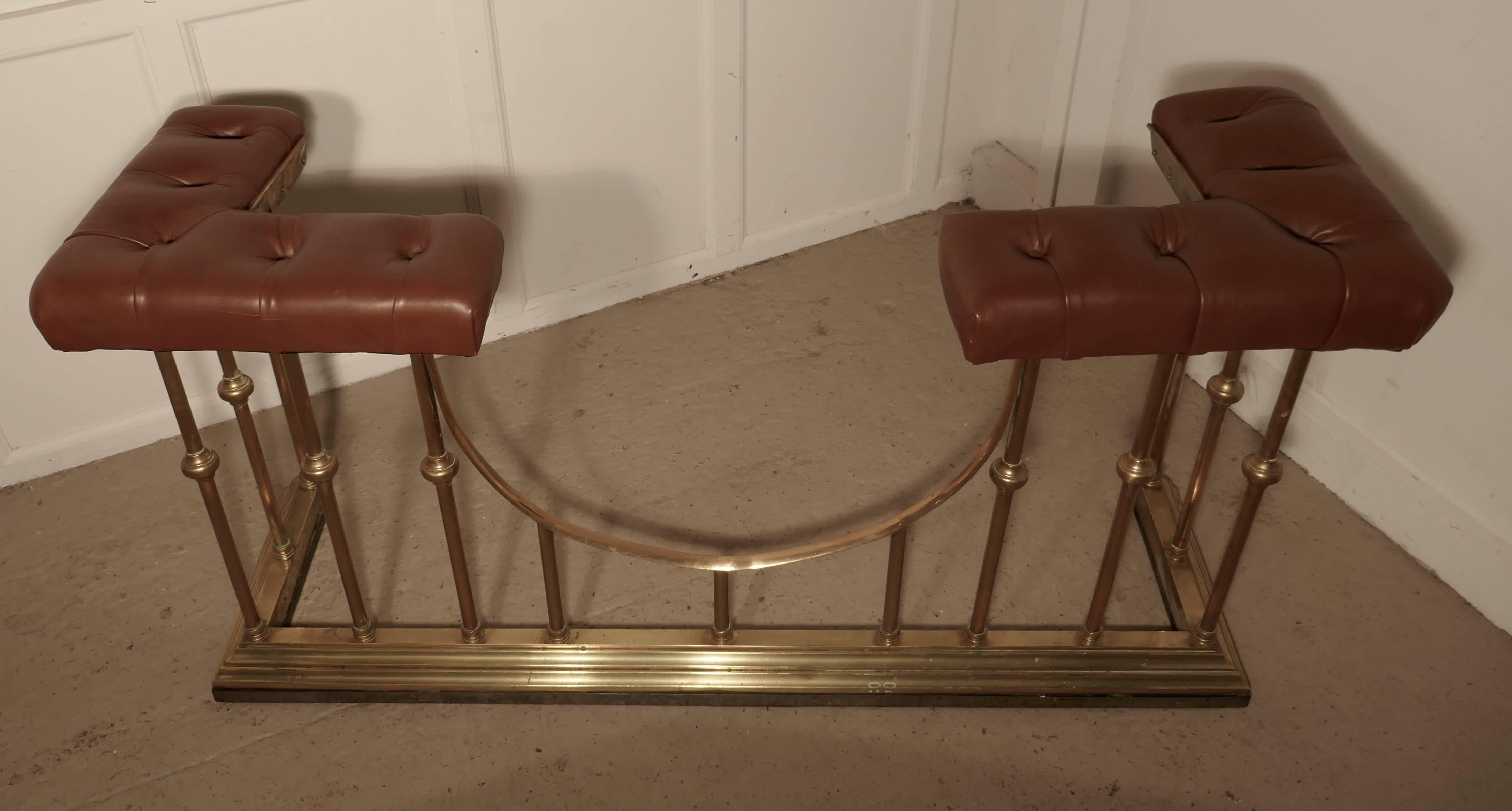This tall and elegant piece of country house furniture and larger than most of this type, the brass fender has chunky turned uprights and seats with deeply buttoned brown leather covering
The fender is in good condition, and the seat is just the