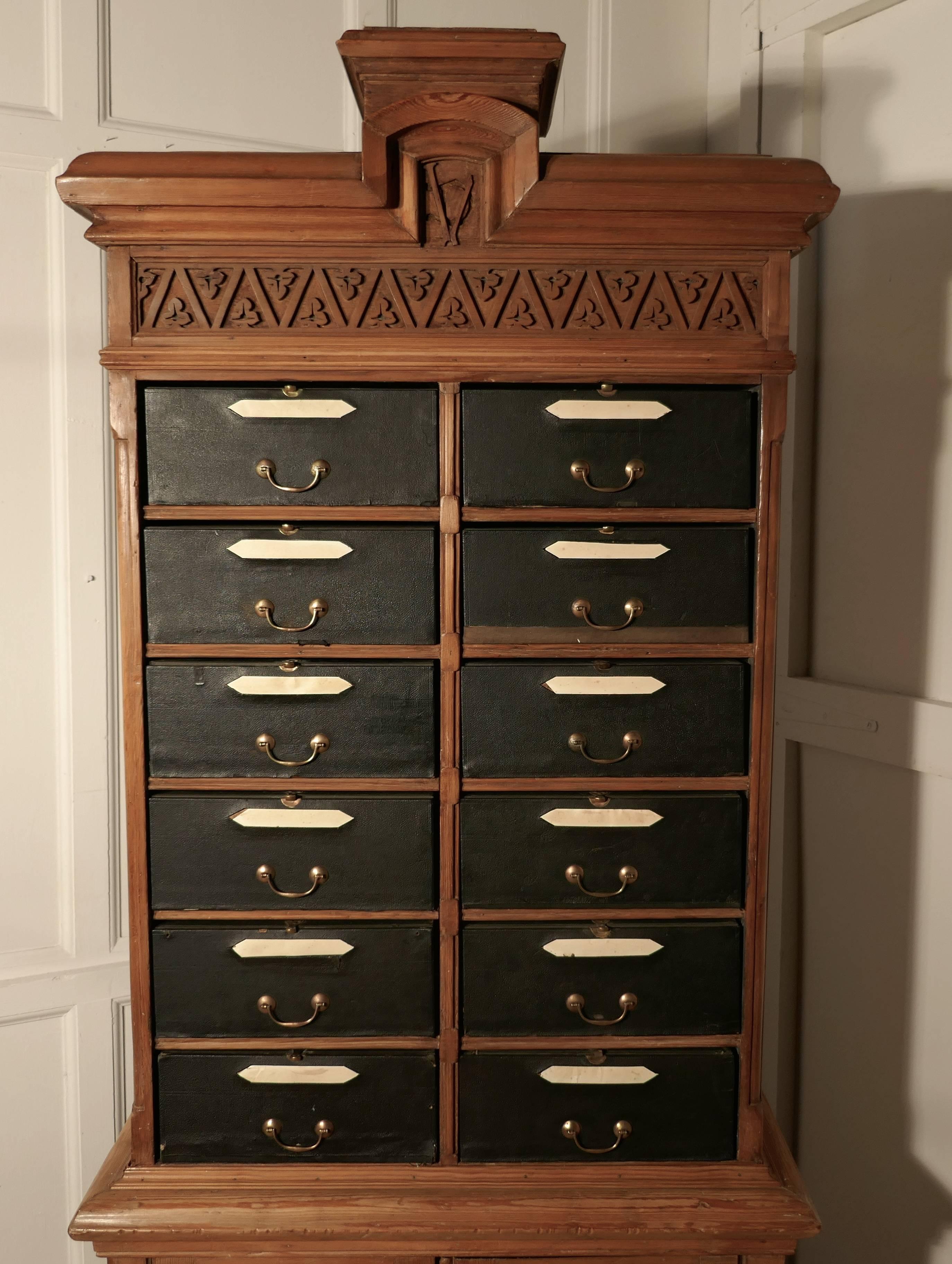 This is a traditional French Cartonniere, the top section holds 10 removable brass fitted box files.
The main body of the cabinet is made in pine and it has a two-door shelved cupboard at the bottom and it stands on bun feet
The files are good