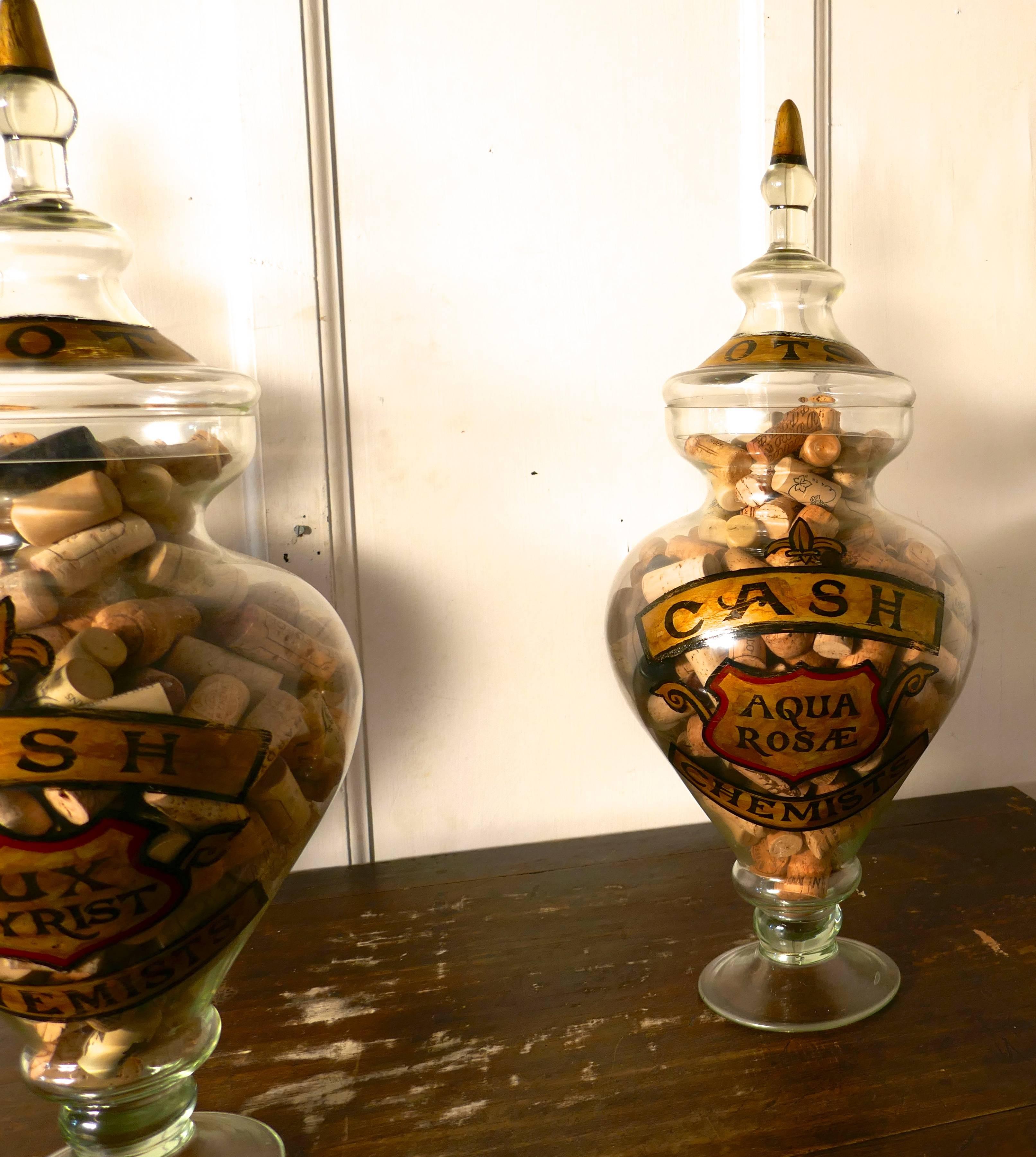 These superb very large jars would have stood on a top shelf of the chemist shop, they were intended as display rather than for everyday use

The jars have gold writing on their deep round bowls, they are in good condition have tall pointed lids,