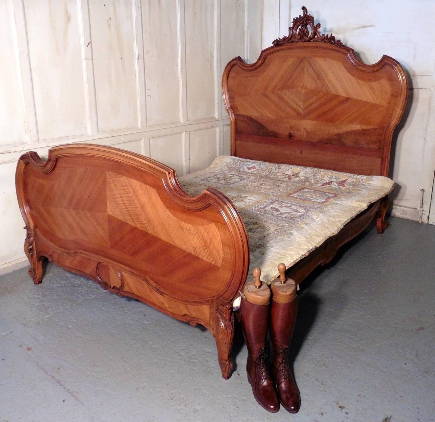 The bed is made in quarter veneered walnut and has a superbly carved crest on the headboard, the carved decoration is repeated on the feet and it comes with a new purpose box base.
The bed is in good condition, it takes a 5ft mattress
The head of