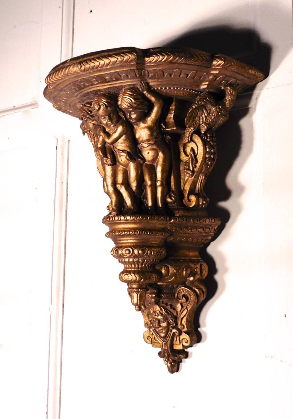 This is beautifully carved piece, depicting a three mischievous putti or cherubs with eagles on either side and a smiling face at the base, the carving is well executed and in perfect detail, the gold is somewhat darkened with age but still bright
