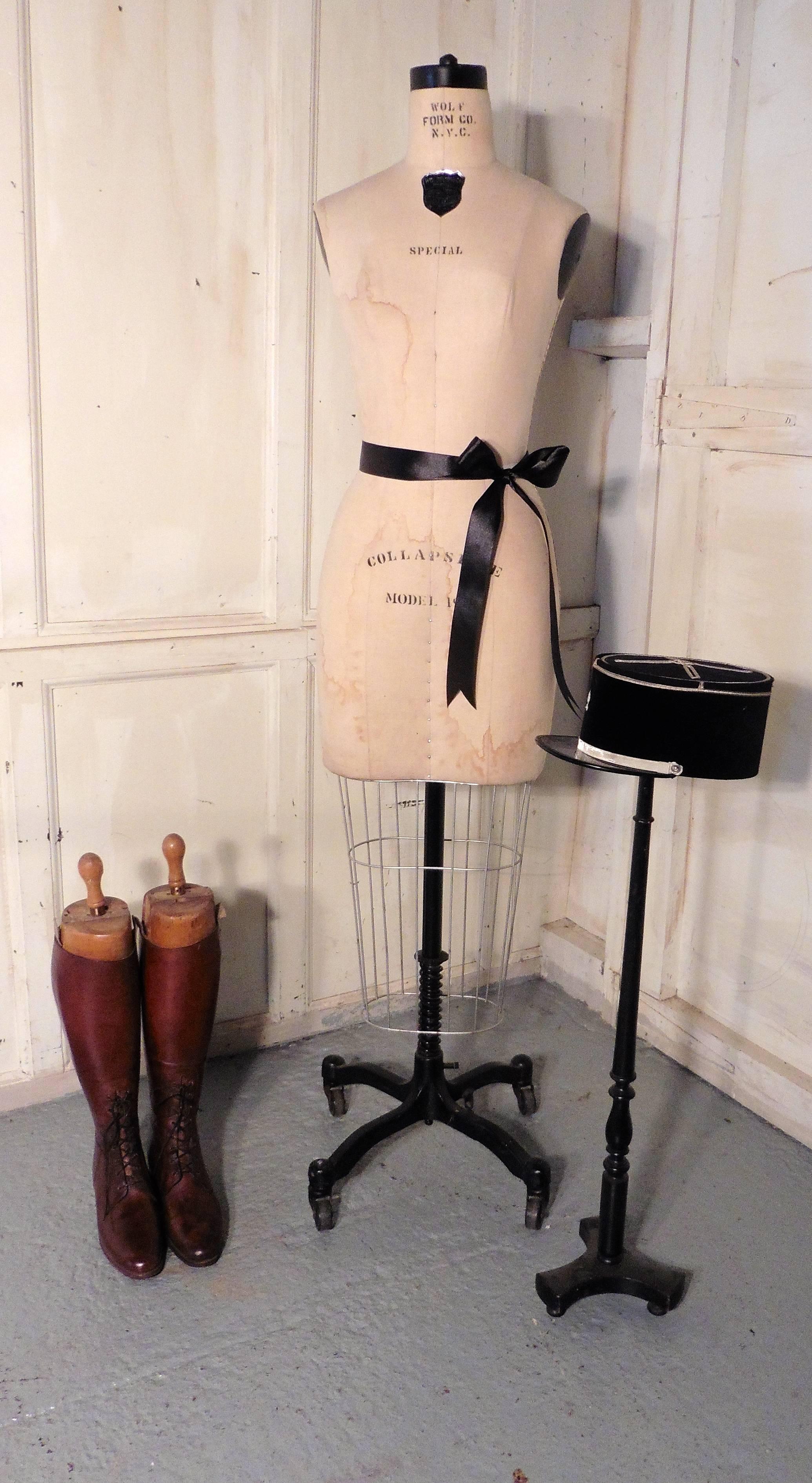 An elegant vintage mannequin, by Wolfrom N.Y.C., this is a good quality piece, she has a wire addition to the bottom of her linen body presumably for the creation of a tight pencil skirt. She has a cast iron stand on casters and is in good all round