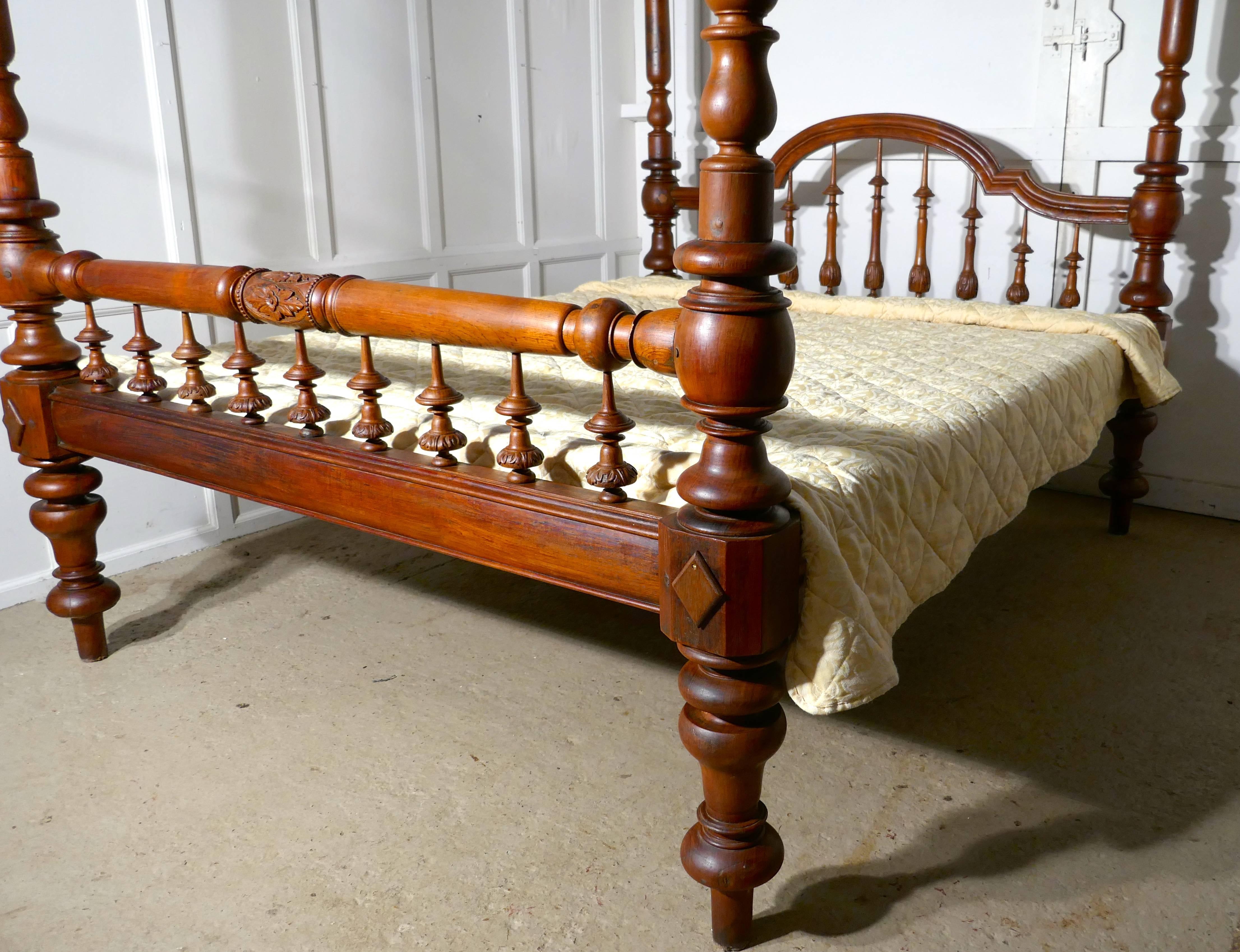 This is a superior quality piece, the bed originates from India often know as a Raj bed, the bed is handmade, it is a four poster with carved turnings and is unusually, a light colour polished wood 
The head of the bed has a pleasant arched shape