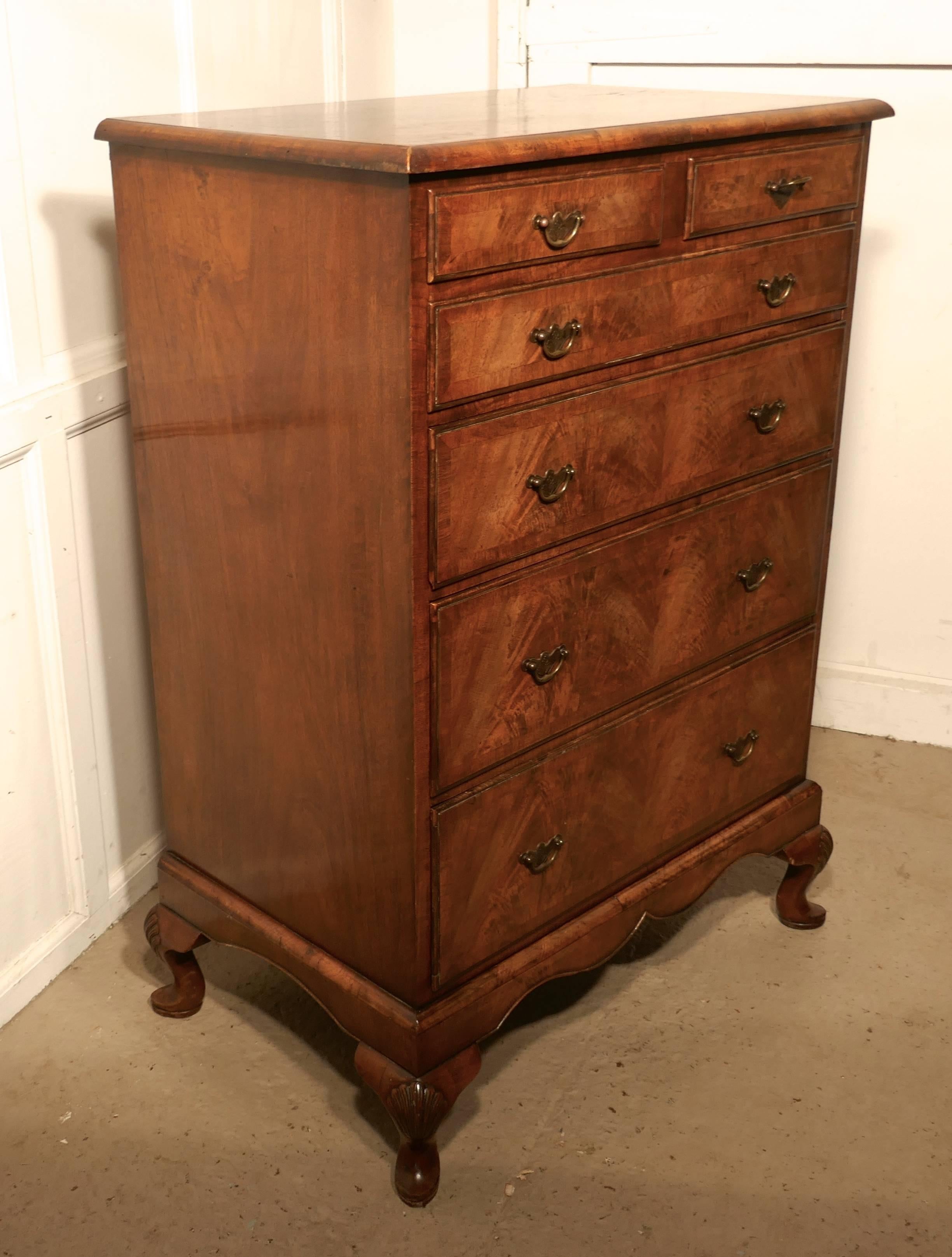This is a superb walnut chest of drawers it has the unusual and very desirable combination of two short drawers at the top and four longer graduated drawers beneath.
The drawers have brass swan neck handles with etched back plates to the handles,