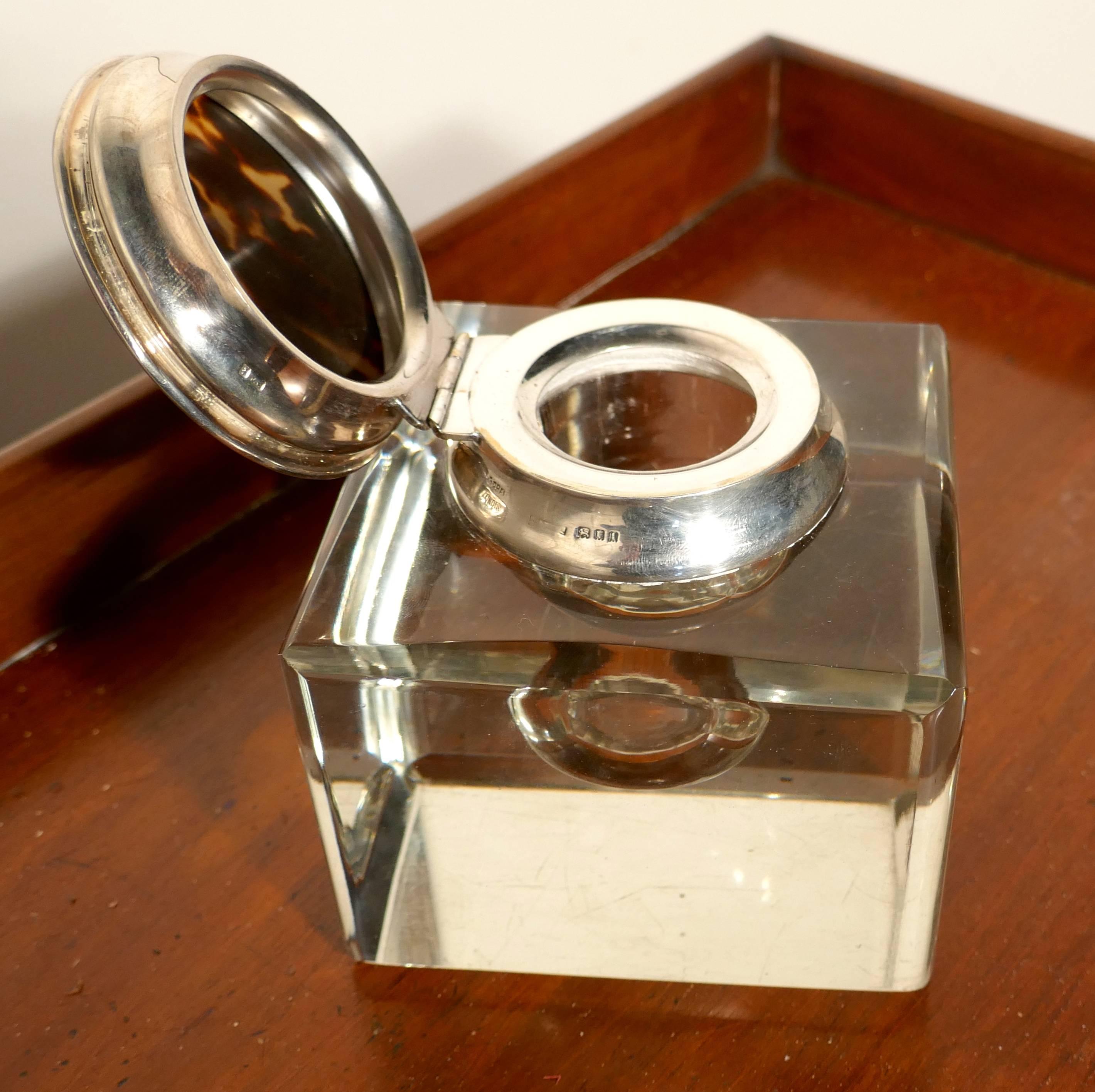 A very stylish piece from a time when style really mattered, the Solid Glass cube shape, has chamfered corners, it is mounted with sterling silver and a simulated tortoise hinged lid which is stamped “Asprey London”  
The glass has very slight