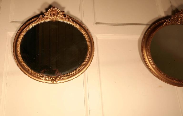 Hand-Crafted Rare Pair of 19th Century Regency Style Oval Gilt Mirrors For Sale