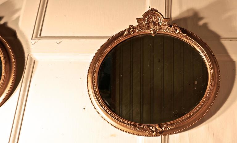 Gesso Rare Pair of 19th Century Regency Style Oval Gilt Mirrors For Sale