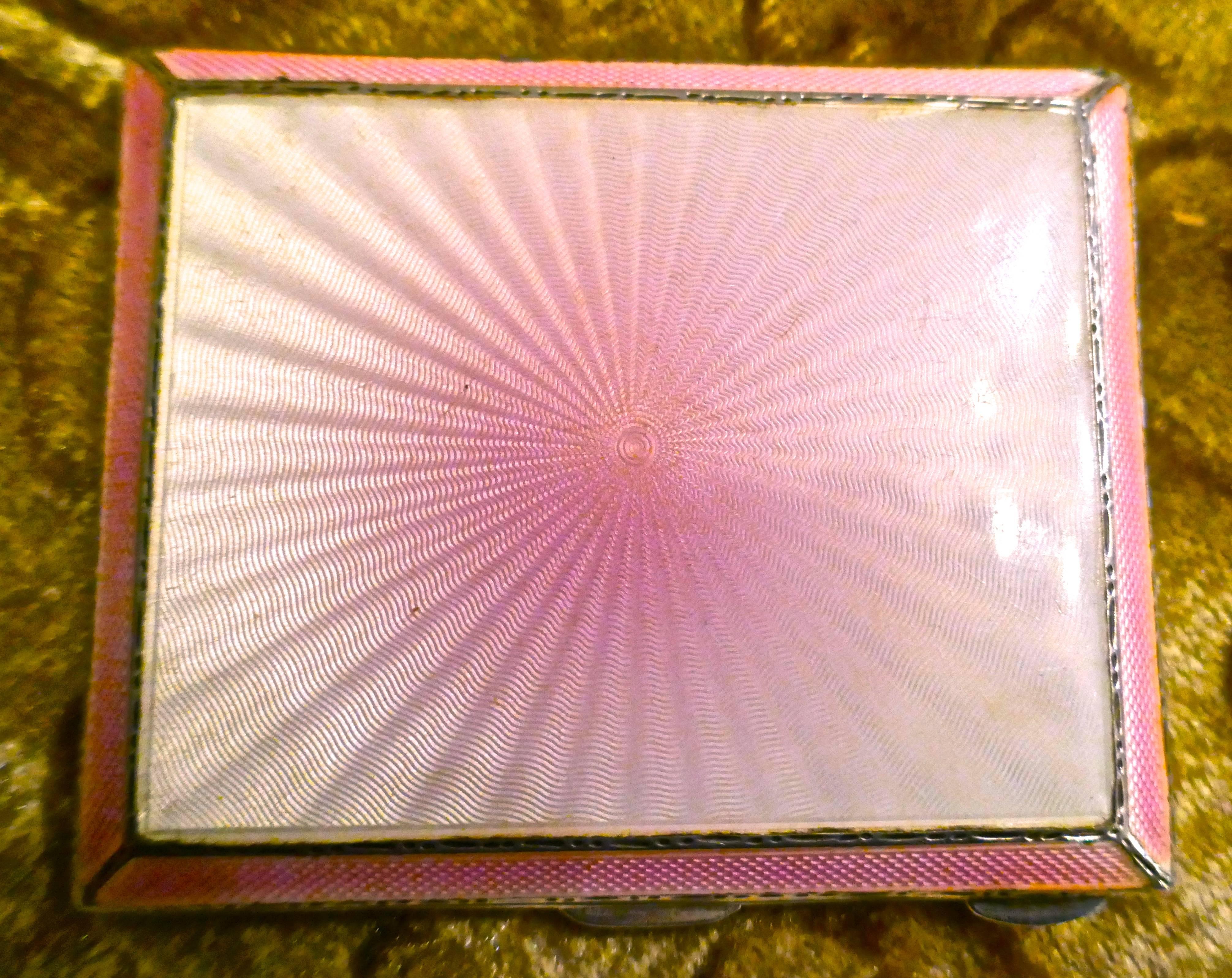 This is a very pretty piece, the rich pink of the enamel at the centre of the box fans out and pales to a rosy glow as it reaches the deep pink border
The case has a beautiful design throughout and although original use was as a cigarette case