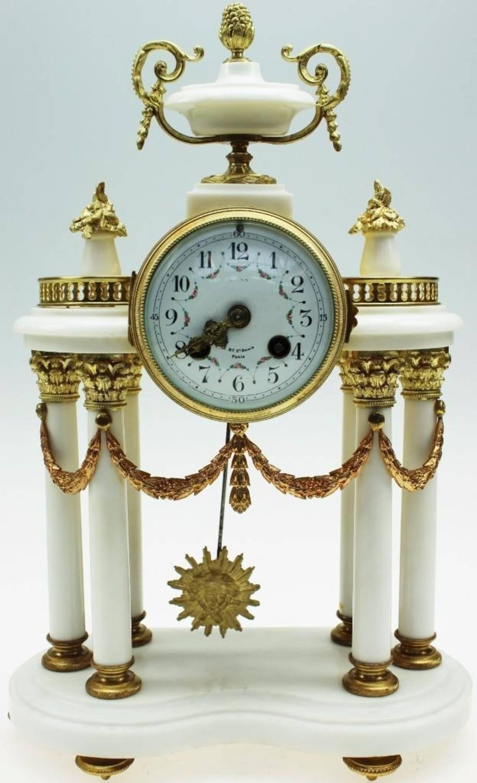 Stunning Napoleon III white marble and ormolu portico clock set including a pair of twin candelabra. The clock is in excellent working condition it has an 8 day French bell striking movement with an anchor escapement with a sunburst pendulum.
The