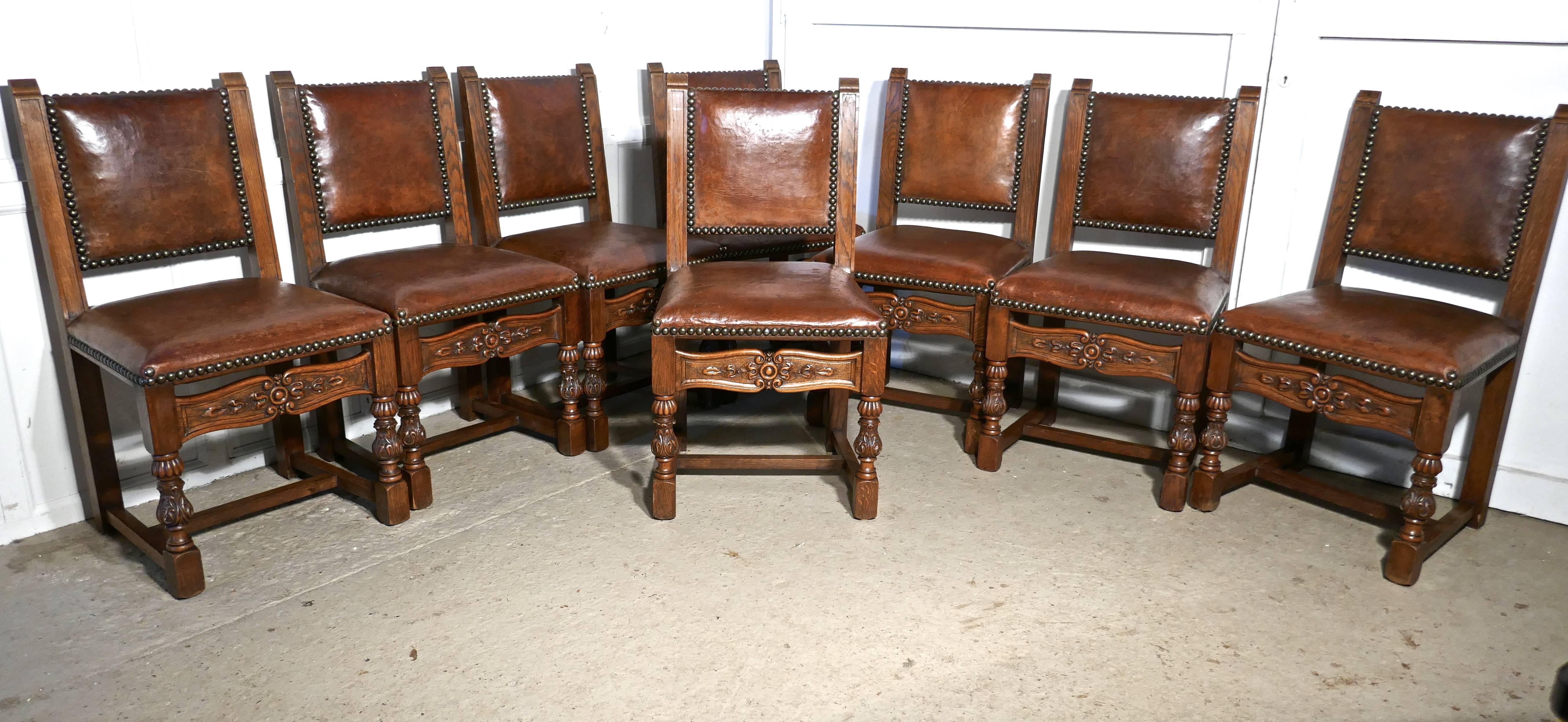 This is a very handsome good quality set of Cromwellian style dining chairs dating from 1880, the oak frames have caved front rails and the chunky front legs have acanthus leaf carvings
The chairs are upholstered in their original brass studded