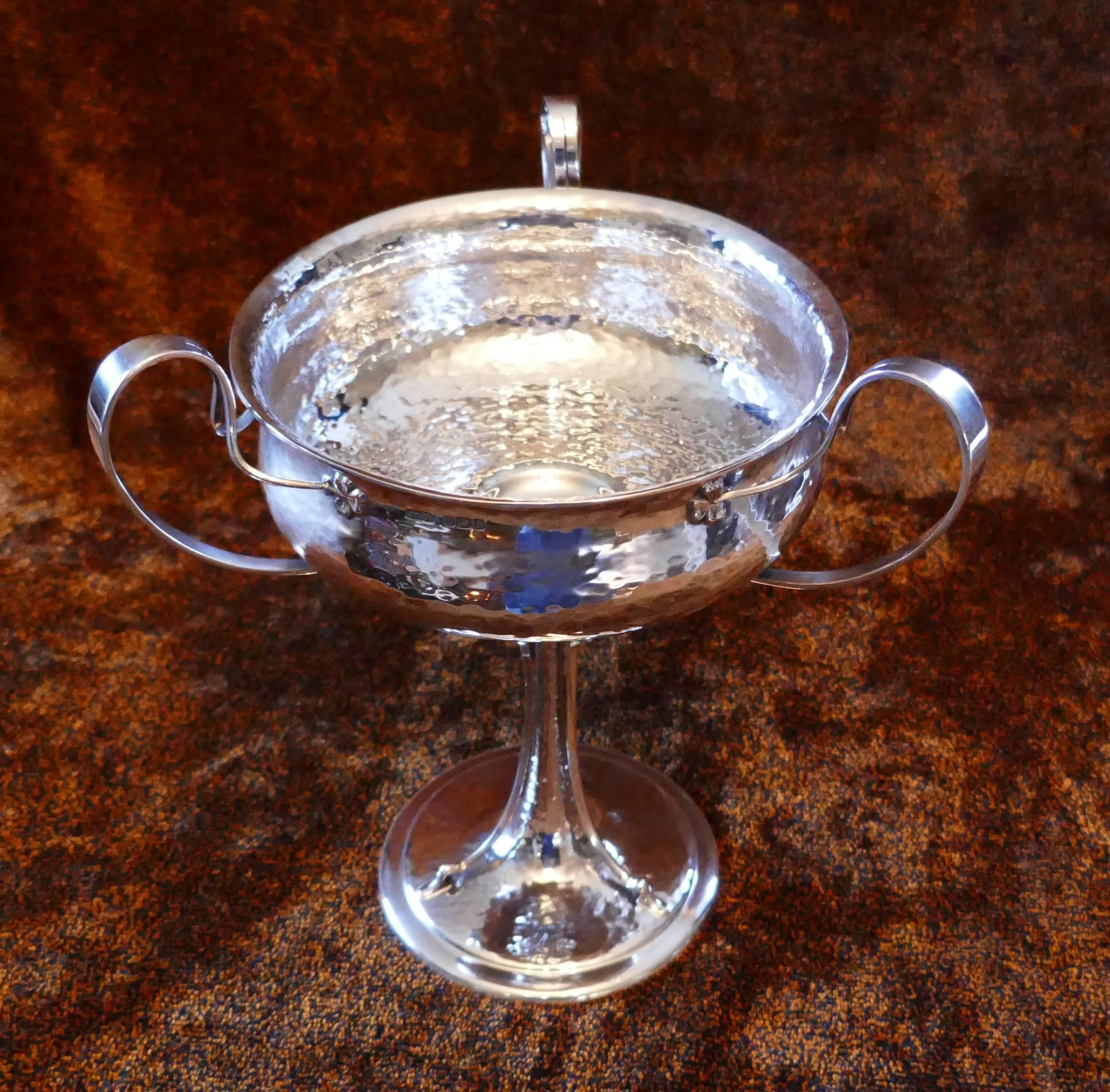 Arts and Crafts centrepiece bowl, beaten silver by James Dixon & Sons

This is a beautifully designed piece of Arts and Crafts silver by one of the masters of this style, the bowl is mounted with three handles in the style of a loving cup. The