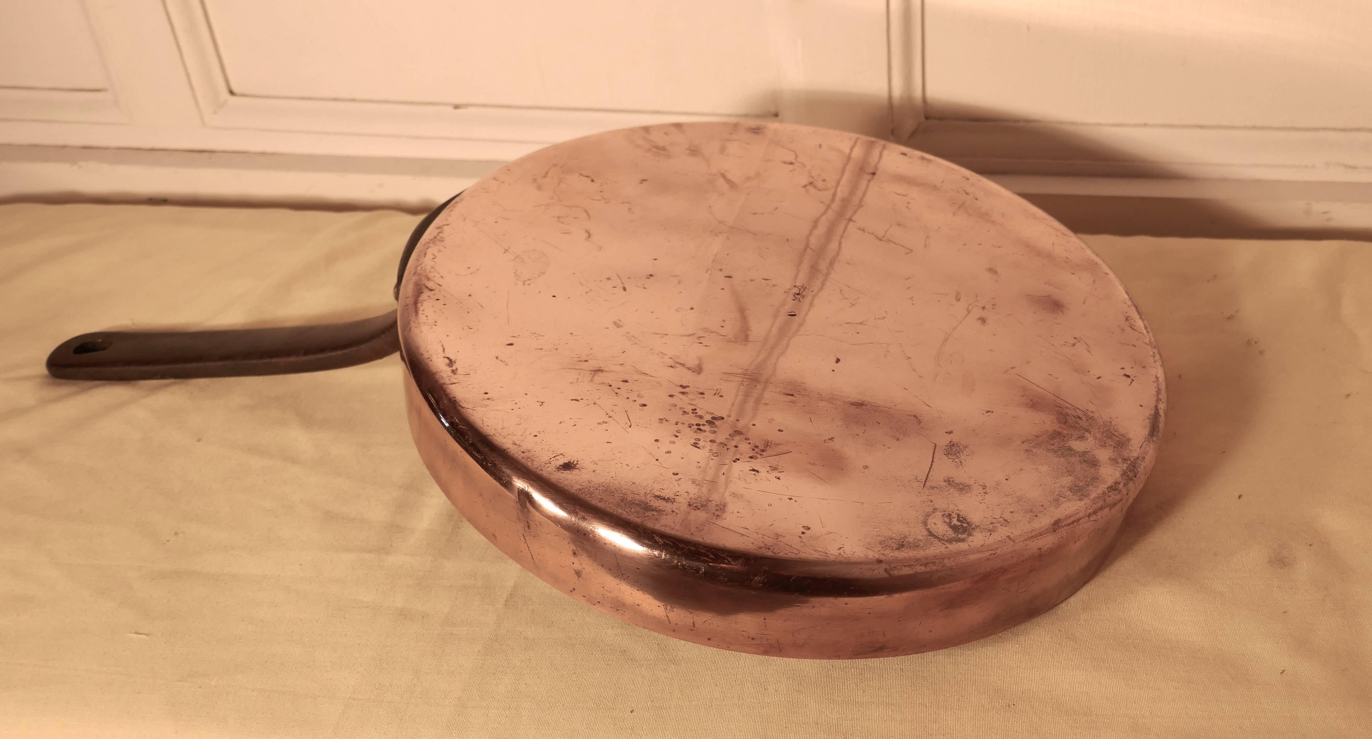 This is a lovely looking 18th century frying pan, the pan was obviously a very treasured piece, it has a riveted iron handle, high sides and is flat bottomed
The pan is in good condition for its age and has a charming patina

The pan is 21”