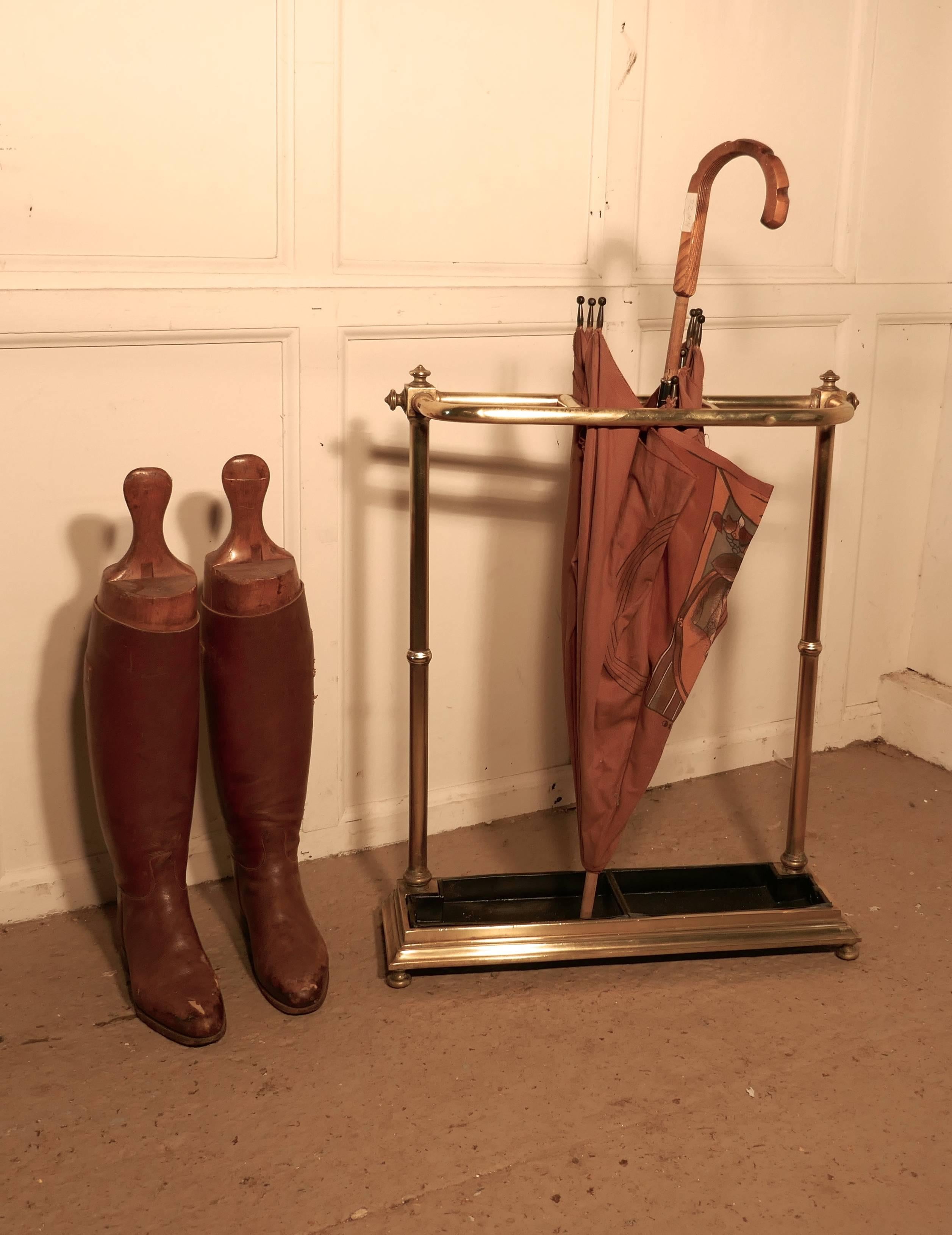 A Victorian brass and cast iron walking stick stand or umbrella stand
 
A charming piece it has an unusual curved shape to the top which is divided into three sections to hold either walking sticks or umbrellas, the heavy iron base has a