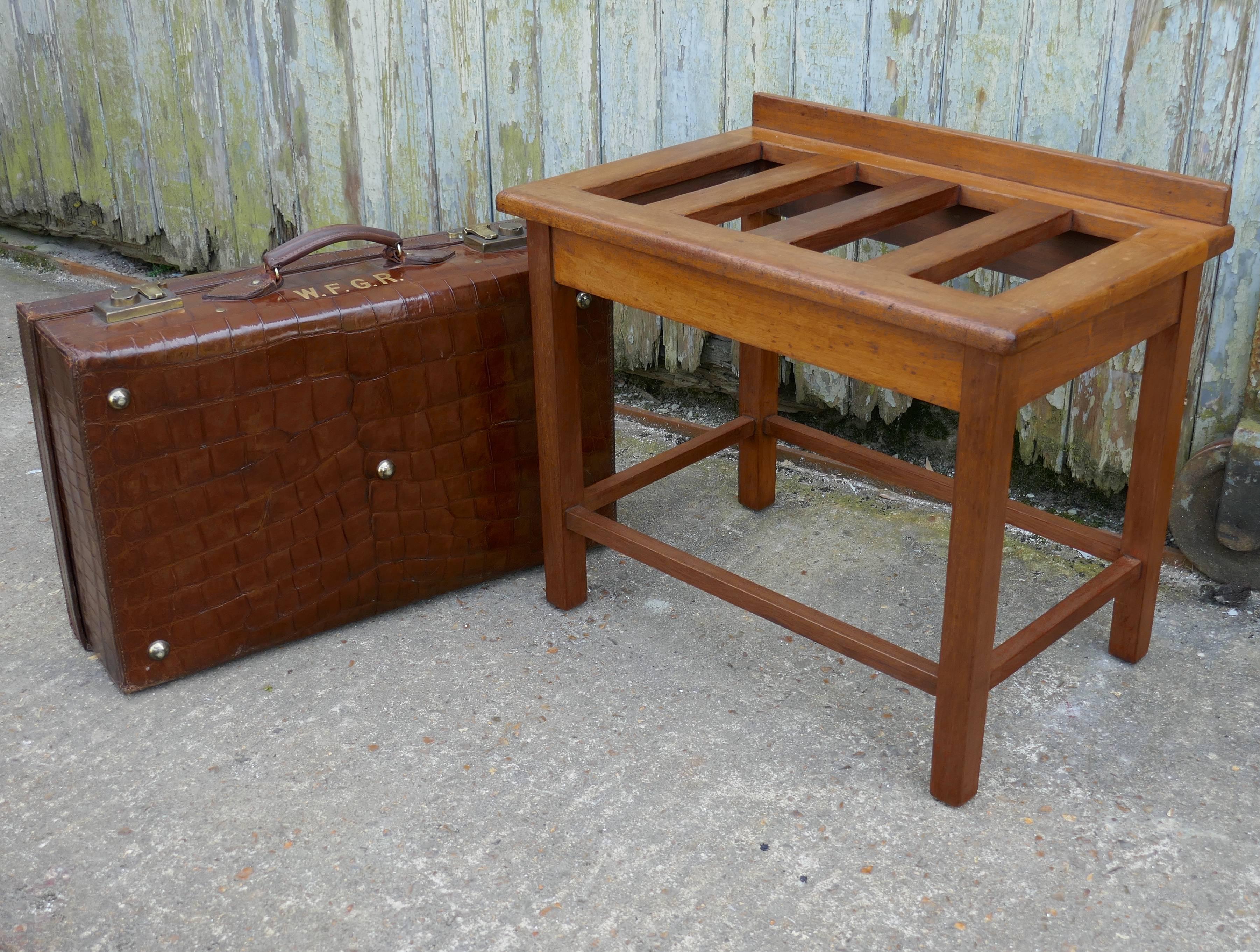 This is a good sturdy piece, it is in mahogany which has a natural bleached patina, it has sleek square lines, the stand is very robust and will take the weight of several suit cases, it has a small gallery at the back
We do have several suitcase