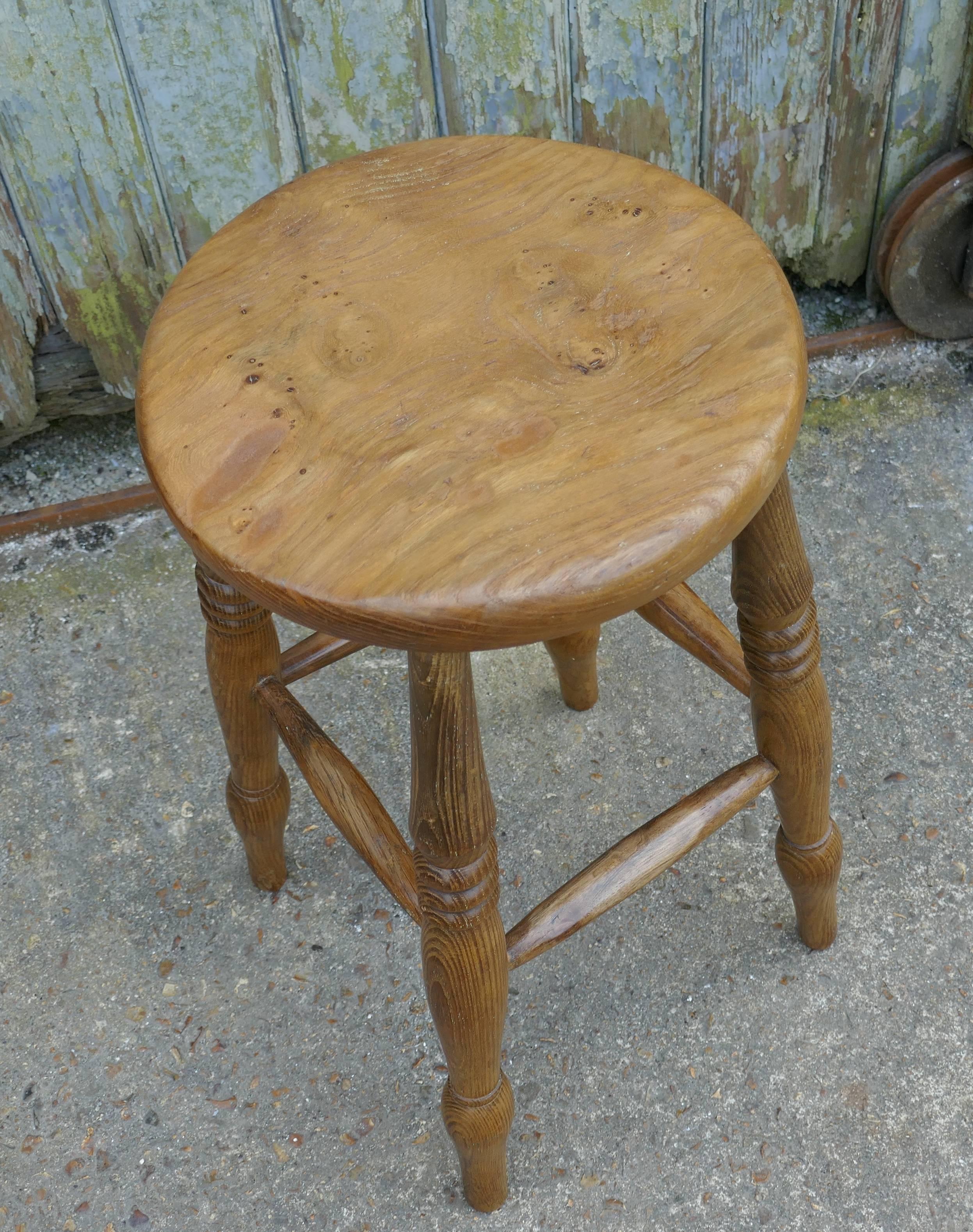 A lovely country piece with a superb natural color and a gorgeous patina, it has a thick elm seat and turned sturdy legs, joined all the way around by stretchers
The stool is good and sound, it is 22” high, 11” in diameter 
RB179.
 