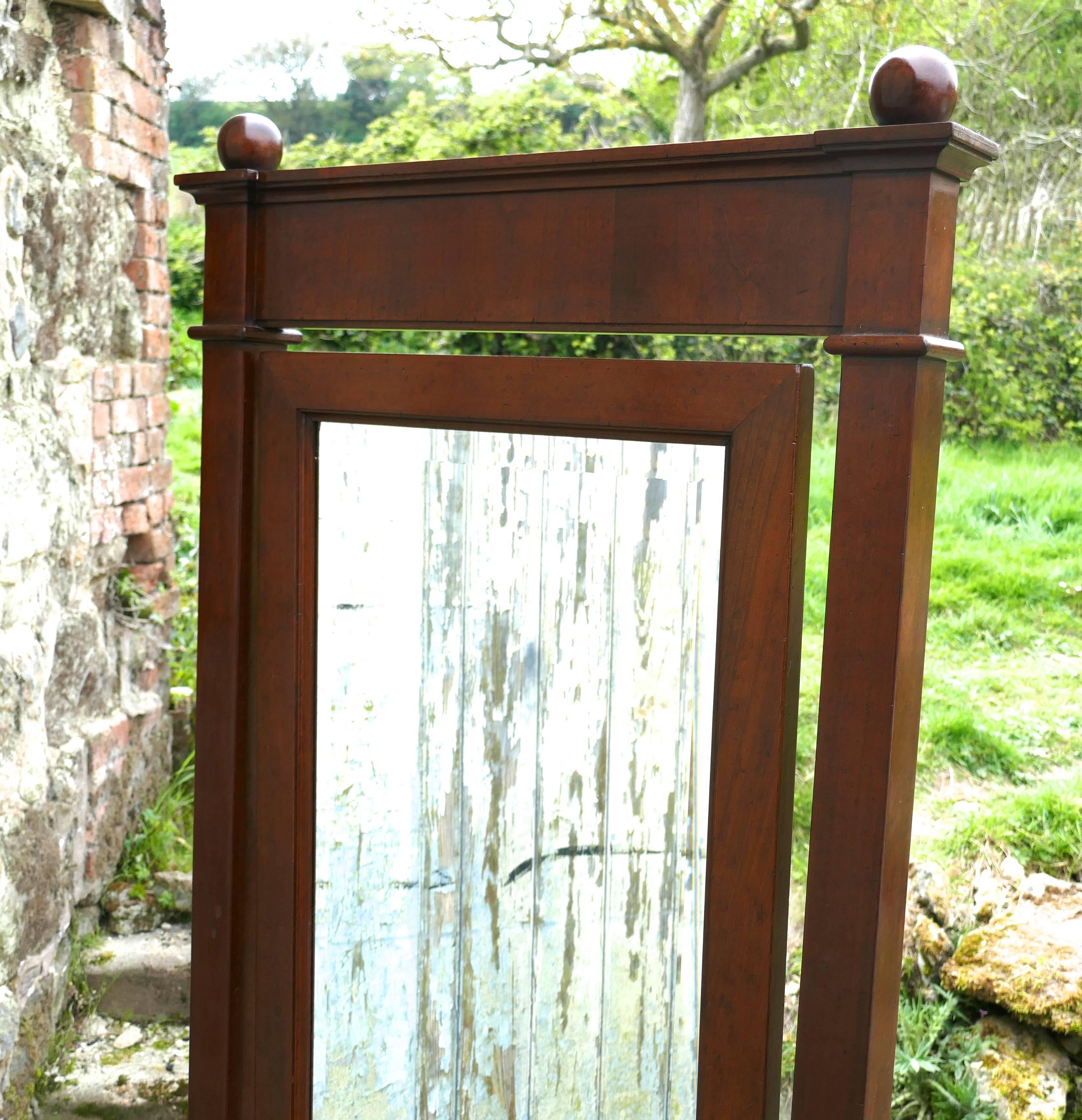 A large 19th century walnut cheval mirror, gentlemans outfitter

This is a large walnut cheval mirror dating from about 1890
The mirror has a solid walnut frame, it is rectangular in shape, it sits firmly in its stand and swivels for maximum