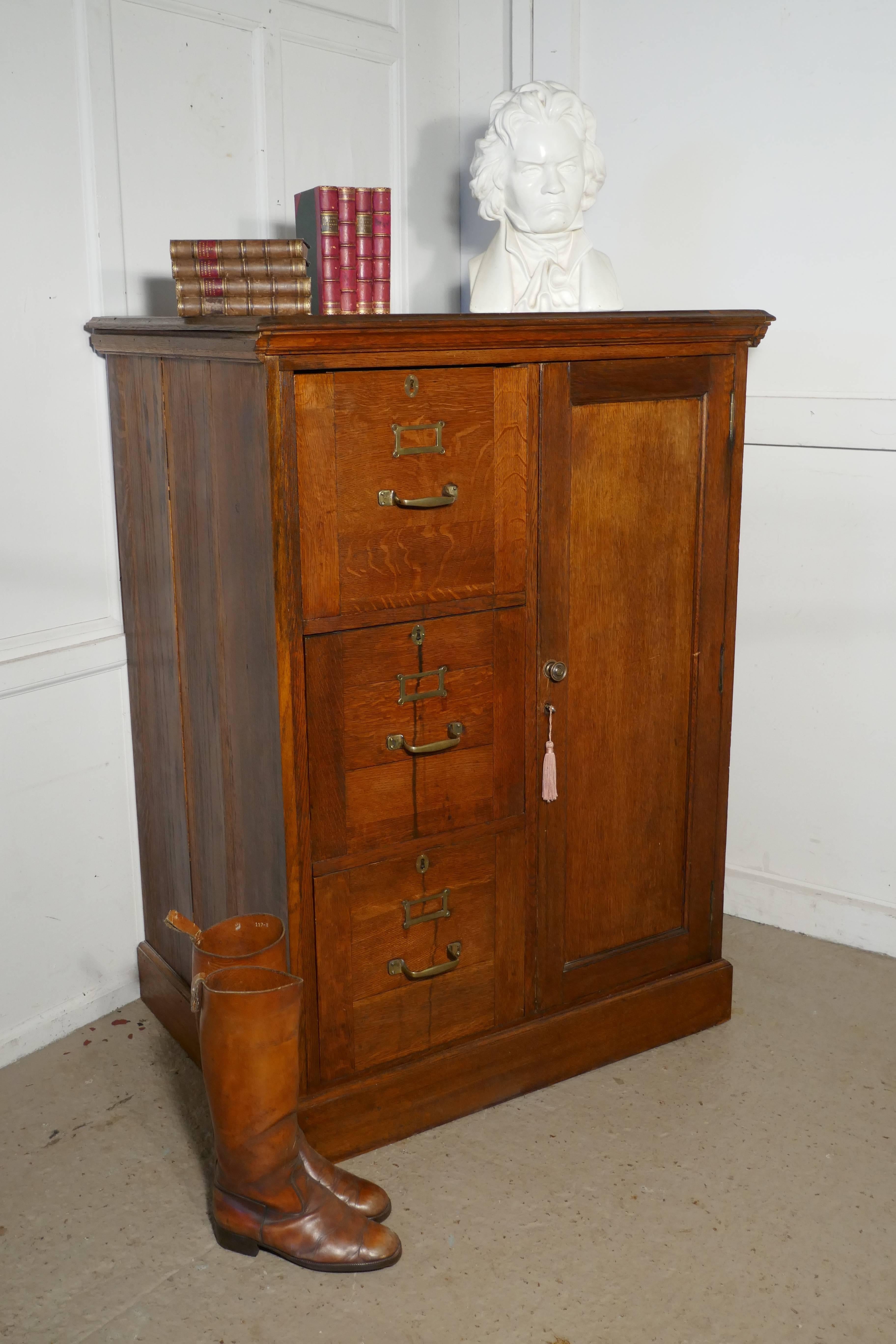 Large Edwardian oak filing cabinet, office cupboard.

This is an absolute must for every home office or study, the cupboard will hold it all. There are three large filing drawers on one side and a panelled door on the other concealing a shelved