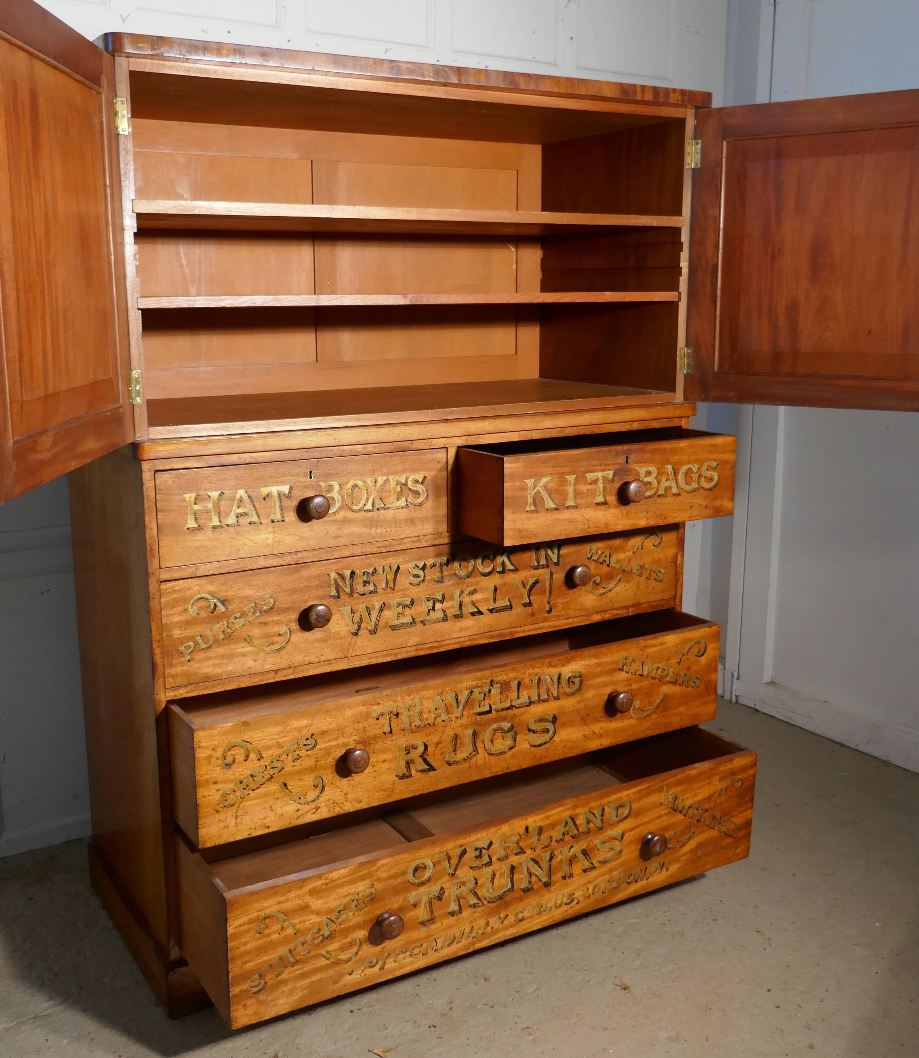 A Victorian blonde mahogany press, advertising shop display

This is a very rare and attractive piece, we have a large size chest of drawers with a panelled door cupboard over. The front of the cabinet has been painted as a display piece for Drew