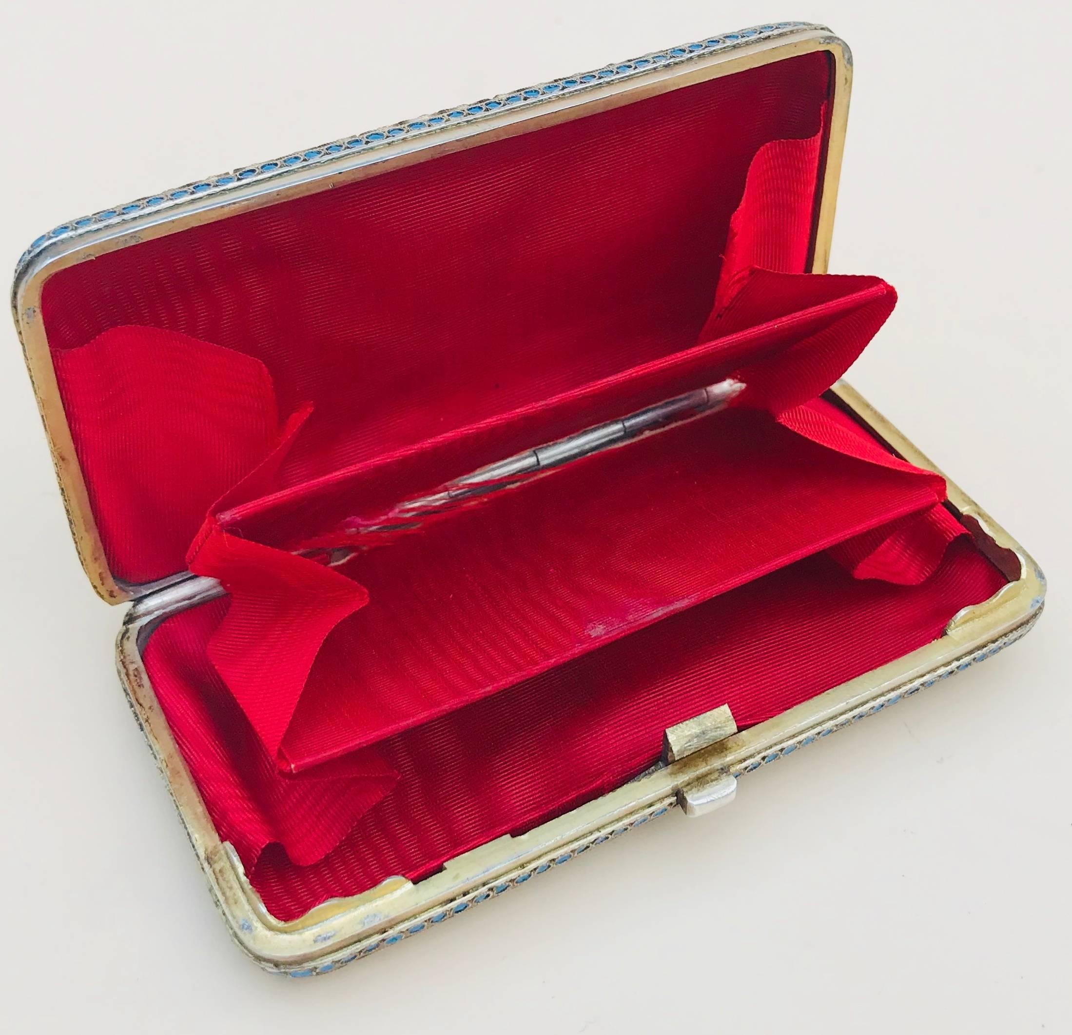 Early 20th century Russian solid silver cloisonné enamel purse or card case

This beautiful piece is lavishly decorated on both sides with a Crimson satin lined interior.
The hinge and clasp are in perfect working order, there is a little wear to