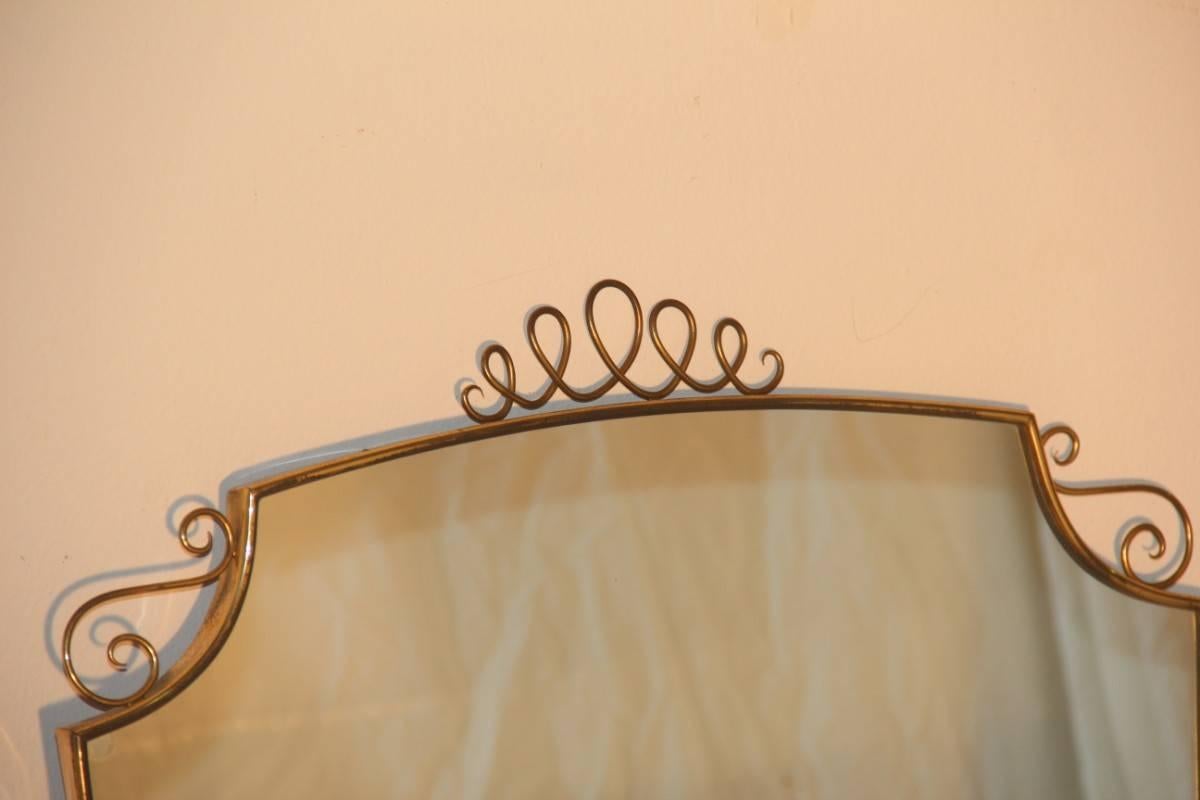 Italian Mid-Century brass mirror, made with lateral brass and decorations that resemble very much the style of the great Gio Ponti.