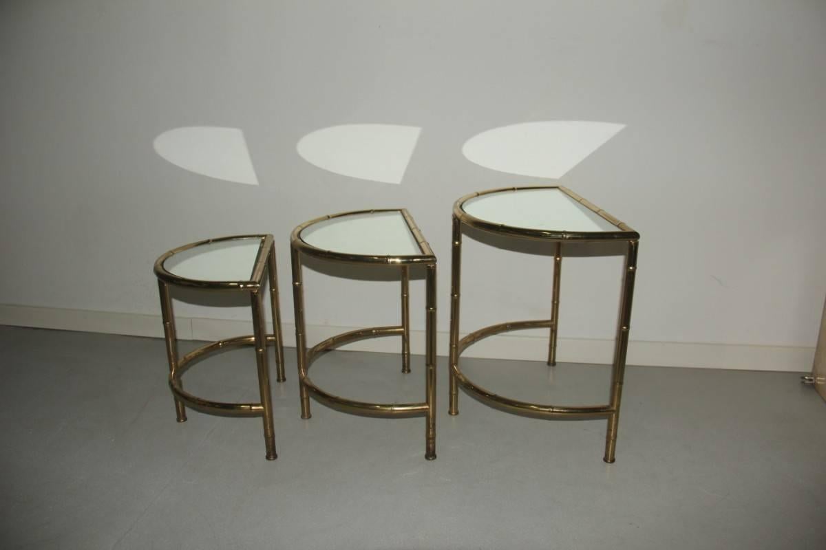 Nesting table coffee 1970s design Italian style, made of solid brass in the shape of bamboo cane, the top mirror. 
The great height 50 cm, width 50 cm, depth 32 cm, 
the average table height 45 cm width 45 cm depth 40 cm, 
small coffee table height