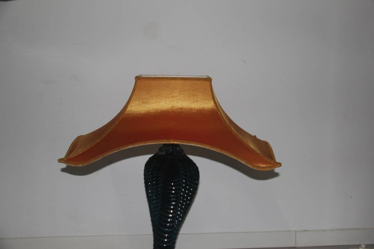 Cobra table lamp Tommaso Barbi Italian design, 1970s, ceramic snake, golden satin dome, elegant and modern at the same time.