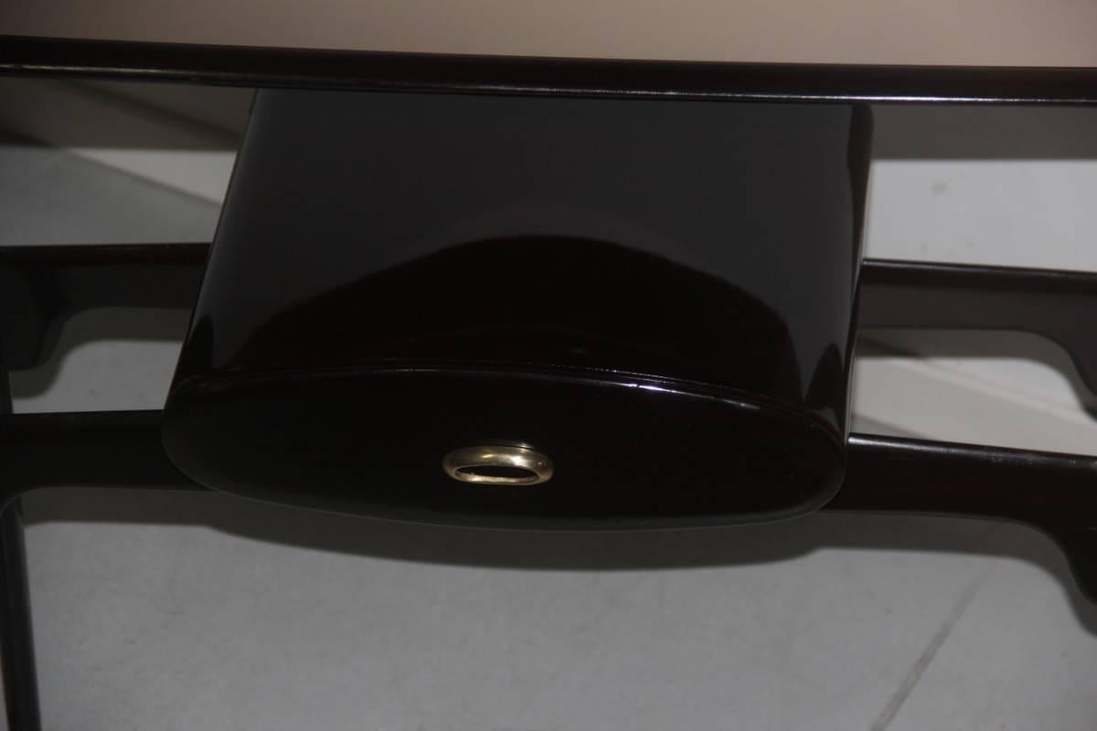 Pair of console of 1950, special shape, oval drawer with brass handle. Measures: Height cm 87.5, width cm 91, depth cm 34.Upper floor in bronze mirror.