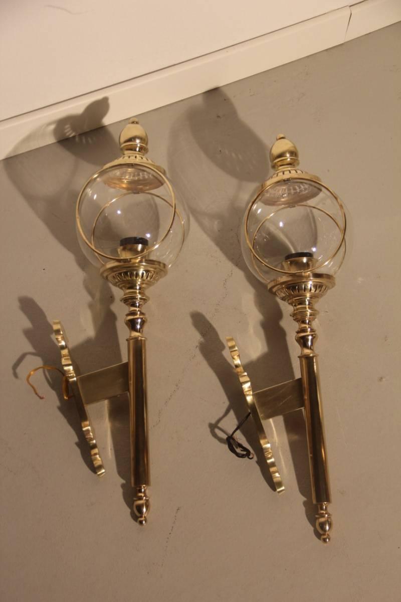 Pair of large 1960s brass applique very stylish design, transparent glass bubble.