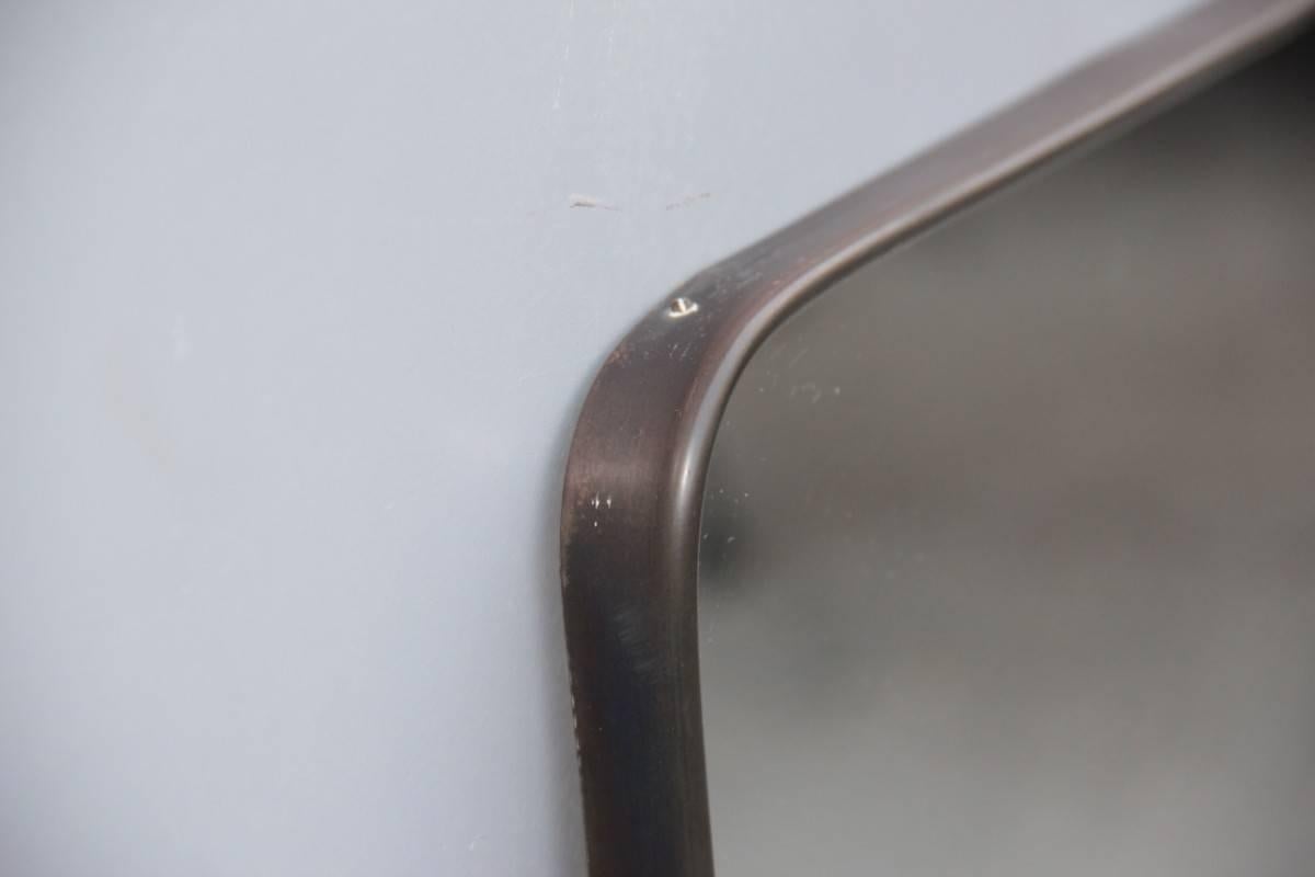 Original Mid-Century Italian design mirror, 1950s brass side frame, its patina is original of its era, but if you want on request we can clean the brass part again making it glossy again as gold.