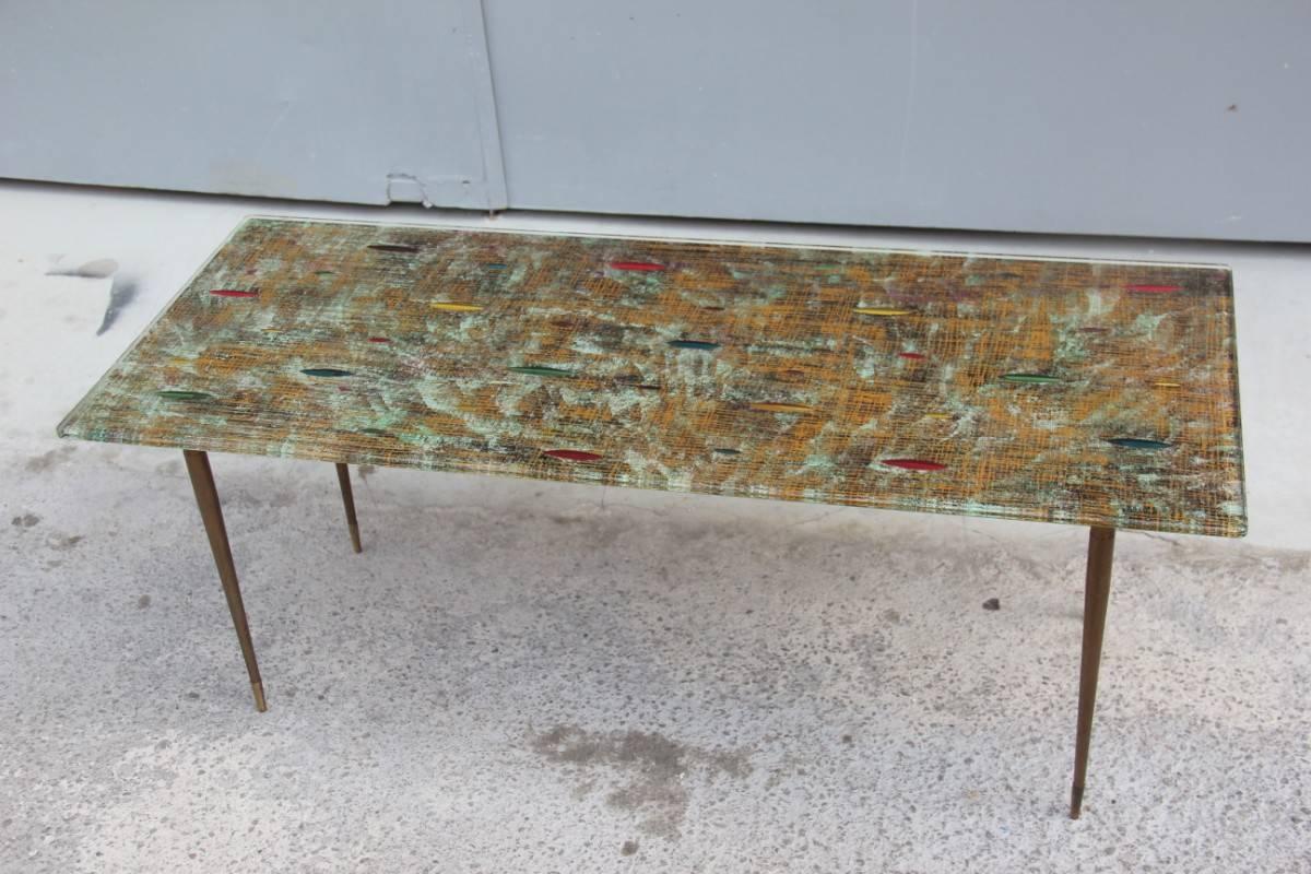 Elegant mid-century Italian coffee table Cristal Art design, 1950s. Metal foot, brass feet, one cm thick crystal plate. With abstract decorations of the 1950s, very elegant and refined table. For simple and minimalistic homes.