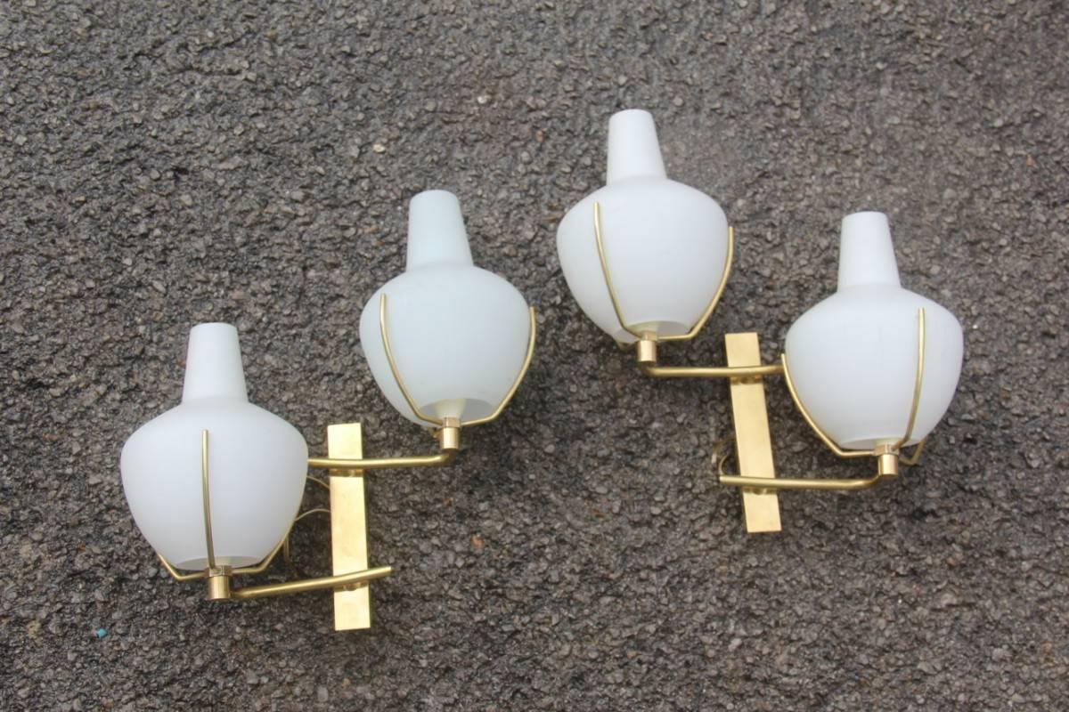 Pair of sconces Stilnovo design 1960s made in Italy, brass and glass,
elegant and very particular design.