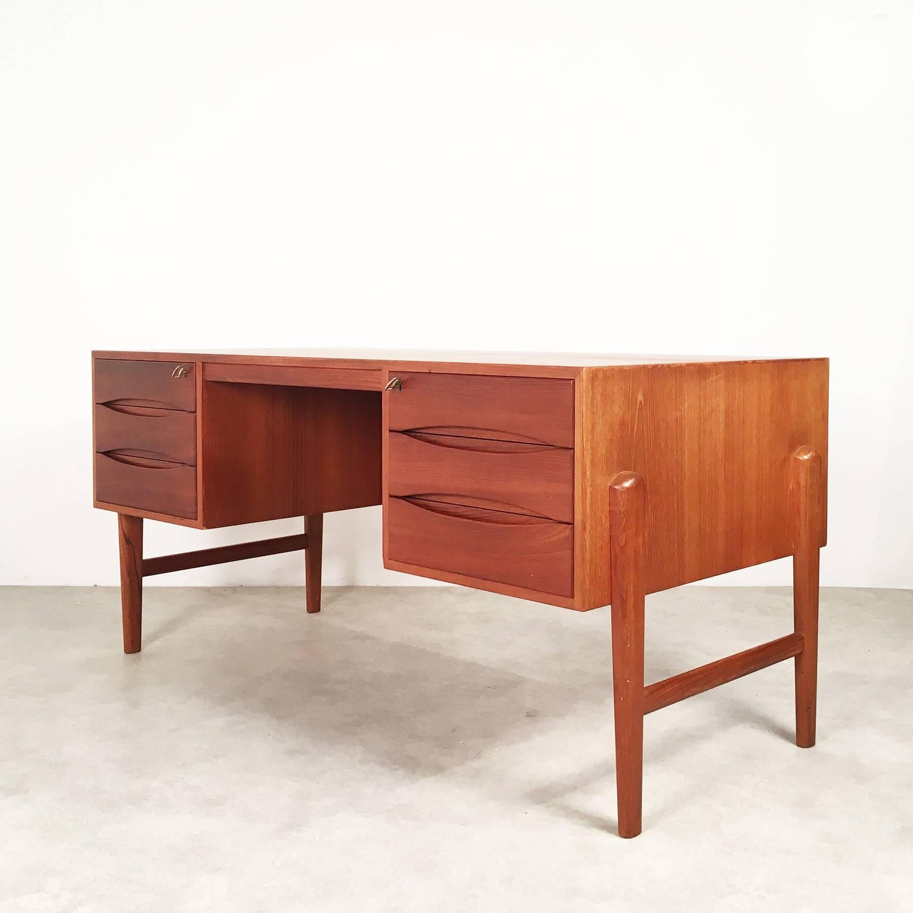 Danish teak writing desk, designed and manufactured in the 1960s. The desk is featured in the 1962 catalogue of Johannes Aasbjerg. Unfortunately, the designer is not stated. Rare model, very well crafted!