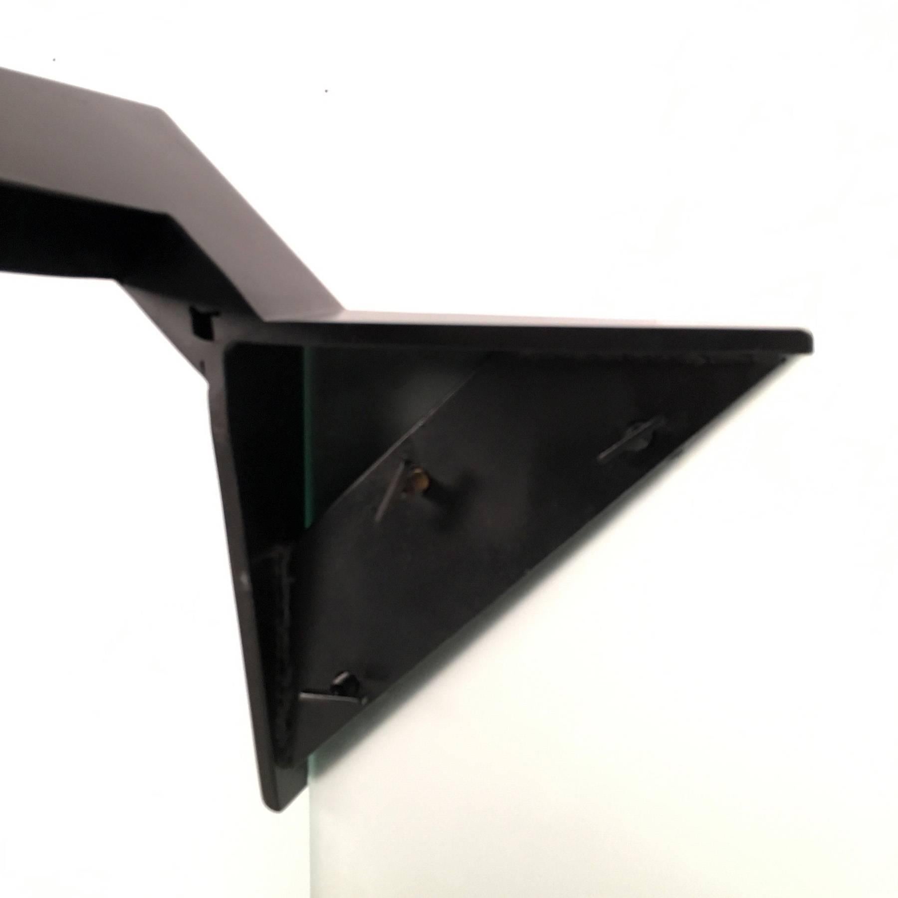 Unusual dining table from the 1980s. The table consists of a square top made of heavy satinated glass, and four legs made of matte black painted steel. The legs are fixed to the top with wing screws. The top can easily be replaced by other materials