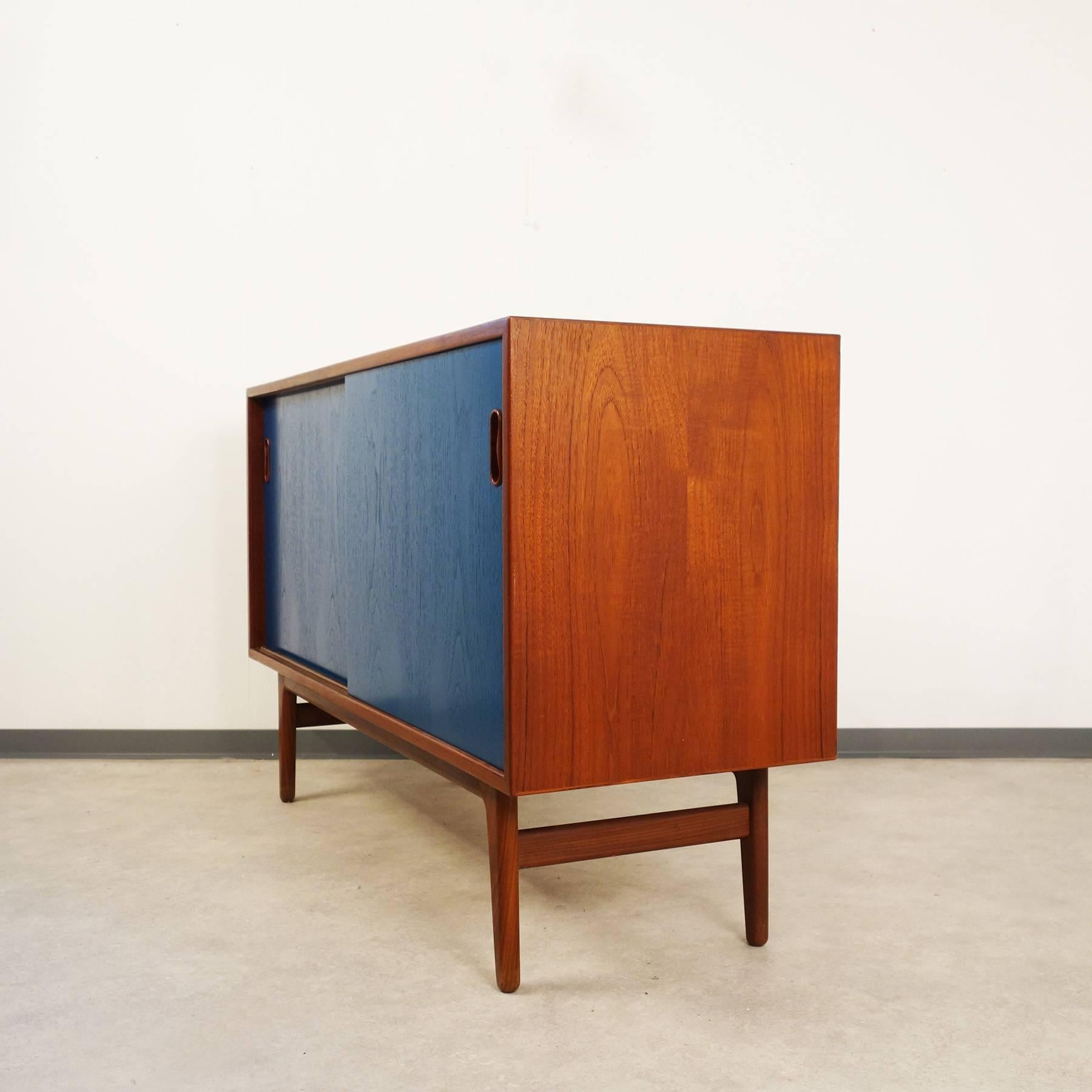 Small teak sideboard, designed in the 1960s by Arne Vodder and Anton Borg, manufactured in Denmark by Vamo Sonderborg. Nice piece in classic Danish design, because of its compact dimensions perfect for smaller spaces. 

The sideboard is equipped