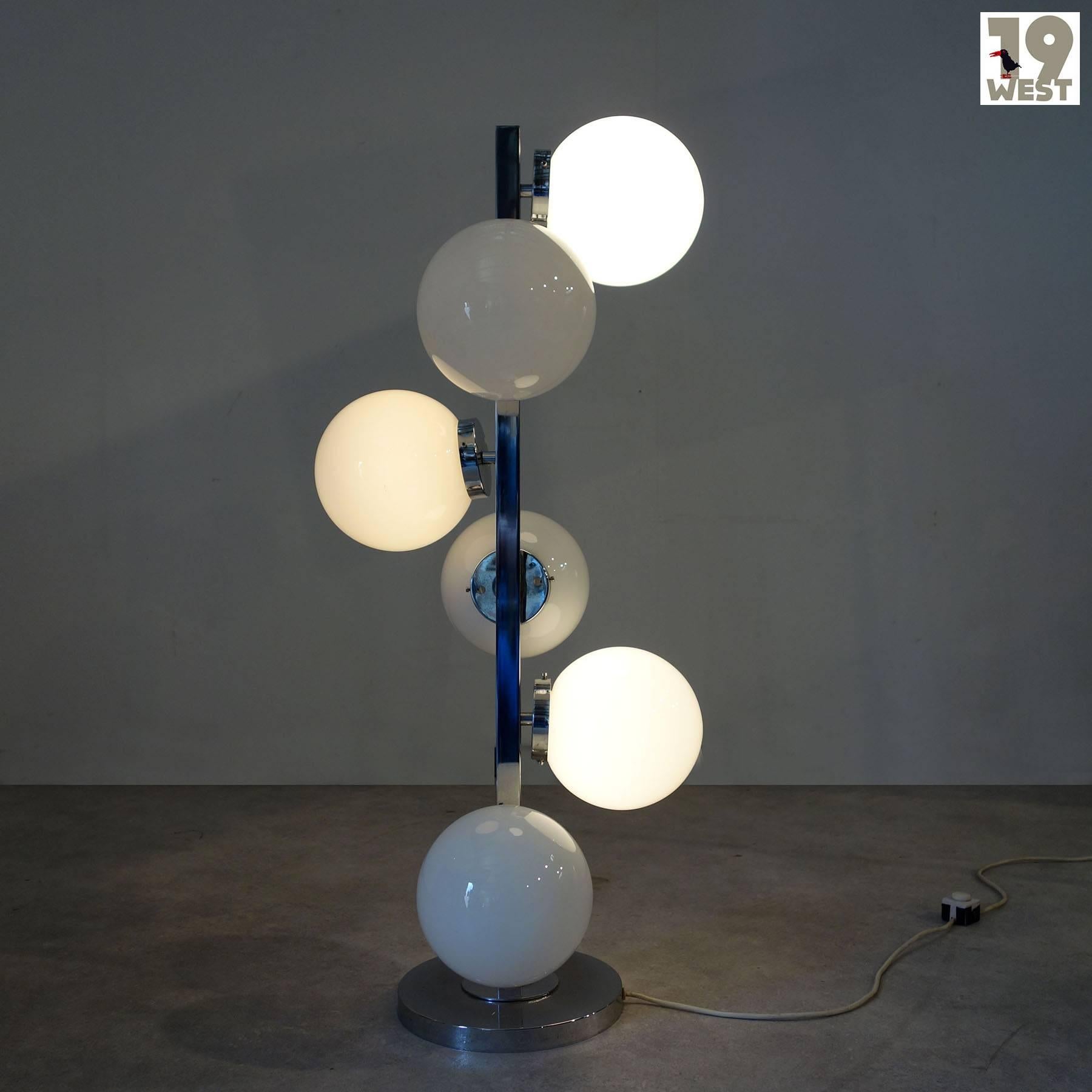 Floor lamp from the 1970s from Italian production, attributed to VeArt. Great model, which consists of a frame made of chrome-plated steel, and six white glass globes. By pressing the switch several times, three of the globes, the other three, or