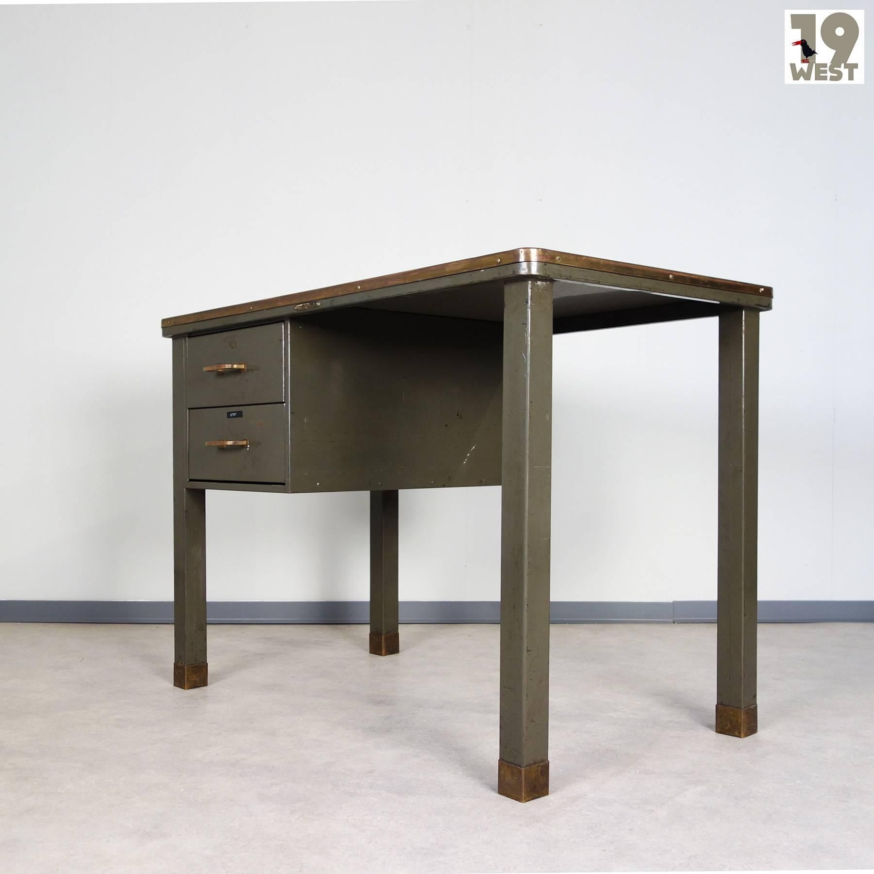 Beautiful writing desk, manufactured in the 1940s in Belgium by Ribeauville Demolder Brussels. The desk consists of green-grey painted sheet steel with several brass details and a linoleum top. It is in a good condition with a lot of great patina.