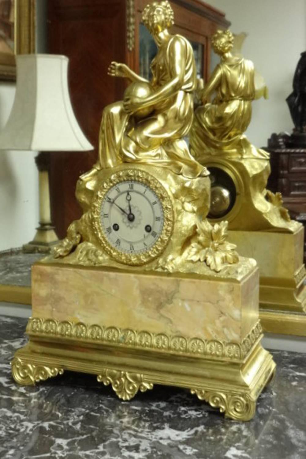 A very good quality gilt bronze mantel clock with beige marble. silvered dial with retard winder, silk suspension pendulum, movement signed Gillion, Etab Lissiment De Paris 1831. Keeps excellent time.