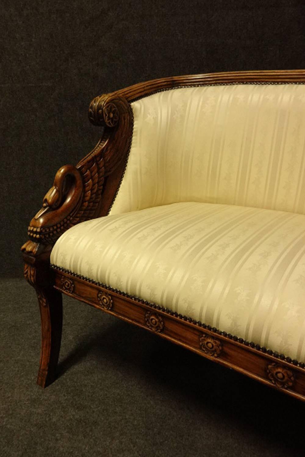 An outstanding curved framed mahogany sofa, with winged bird Egyptian influence,
reeded frame with some bleaching, lozenge shapes to frame base, lovely color and condition.