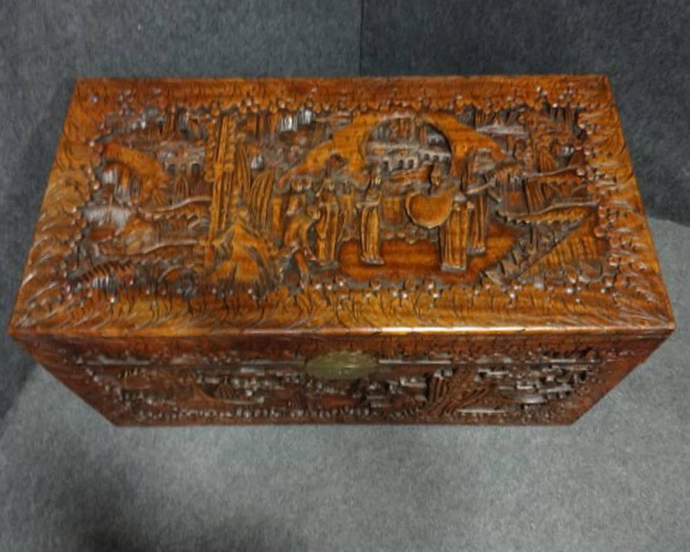 A very good carved Chinese camphor wood chest, carved on all sides, very good color and condition, can be used as a coffee table.

Measure: 41