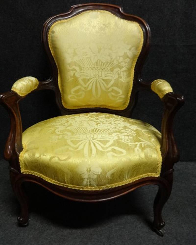 Newly upholstered in Italian silk, we have a very good pair of Victorian rosewood elbow chairs, castors to the front legs, very good color and condition.