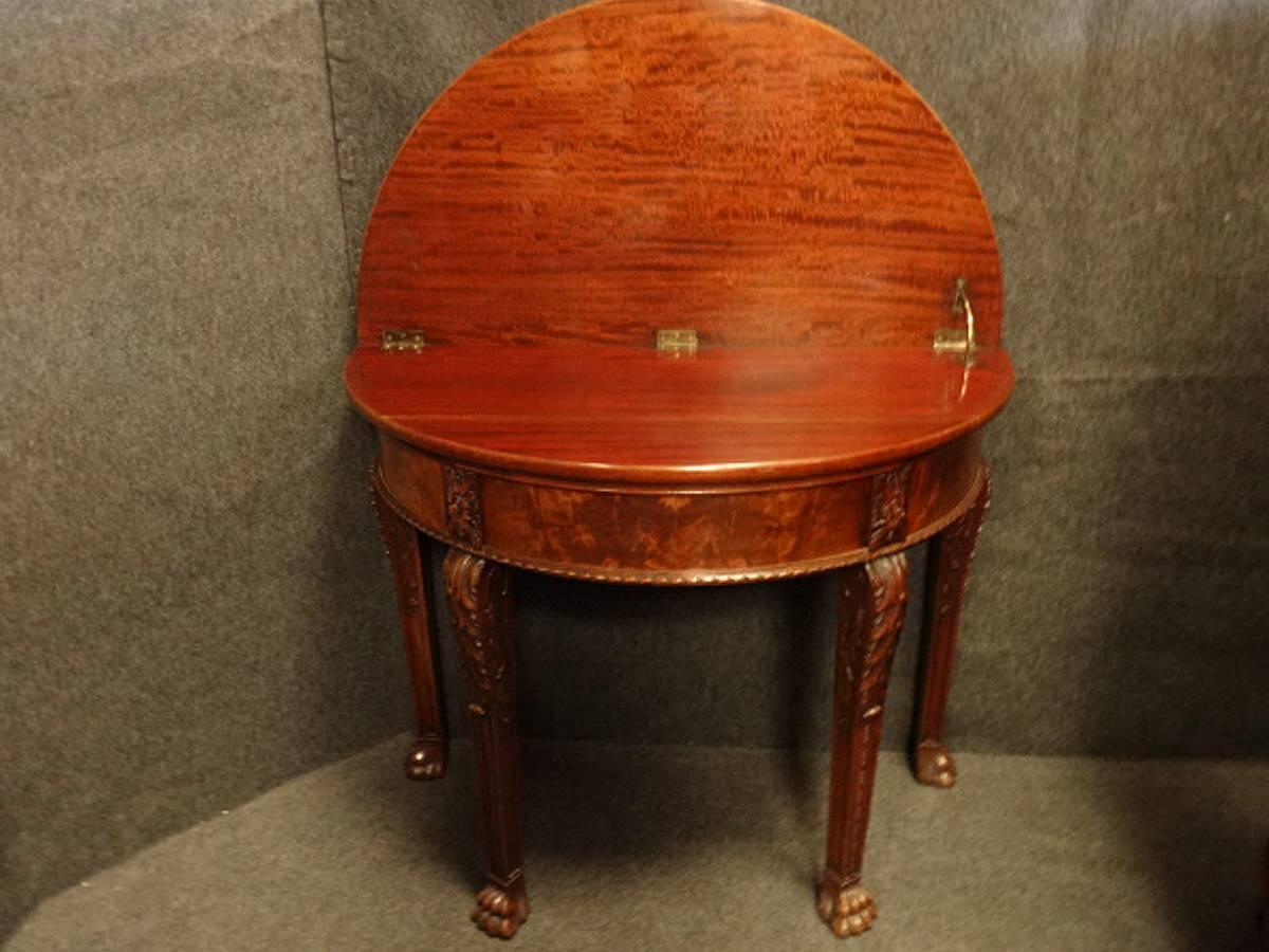 Top quality Irish carved mahogany demi lune console table by Maples, (Maples registration no.) in the early Georgian Kentian style with central drawer, top lifts up to provide a back, in excellent original condition.

Measure: 41.5"