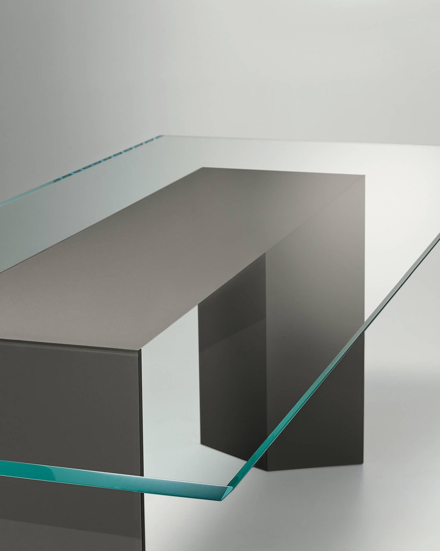 Table with 15 mm extralight glass top, painted only in the middle part as per samples in the bright version. 45° bevelled glass top. Wooden base covered by painted glass as per samples in the bright version. Dolm is suitable for modular compositions