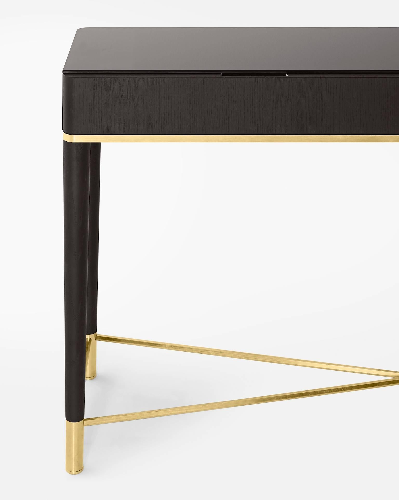 Console with black lacquered ash drawers. Satin brass and satin brass lacquered aluminium details. 6mm bright liquorice painted tempered glass top.

Sizes:

Inches
47.25 x 14.25; x 32.75 H
55.25 x 14.25 x 32.75 H