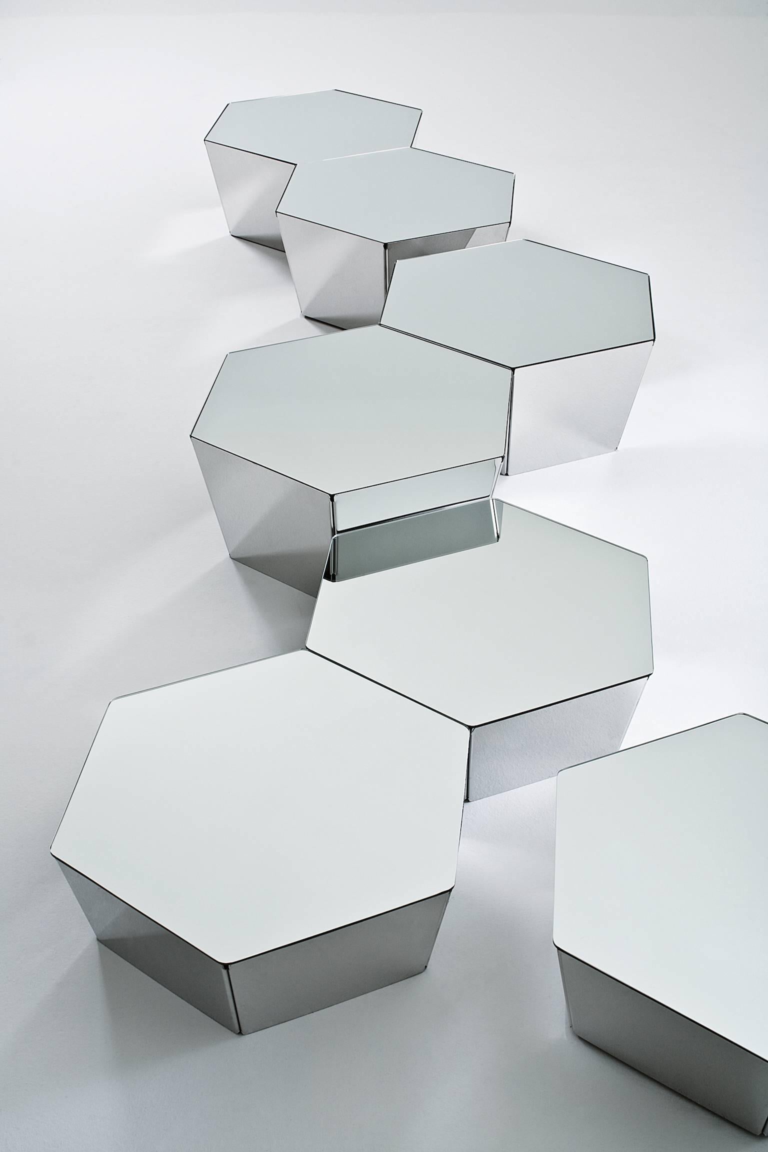 Coffee table to be placed side by side, with hexagonal conic metal base available in different versions: A: “supermirror” bright stainless steel structure with mirrored glass top. B: Embossed white lacquered metal structure and bright white painted